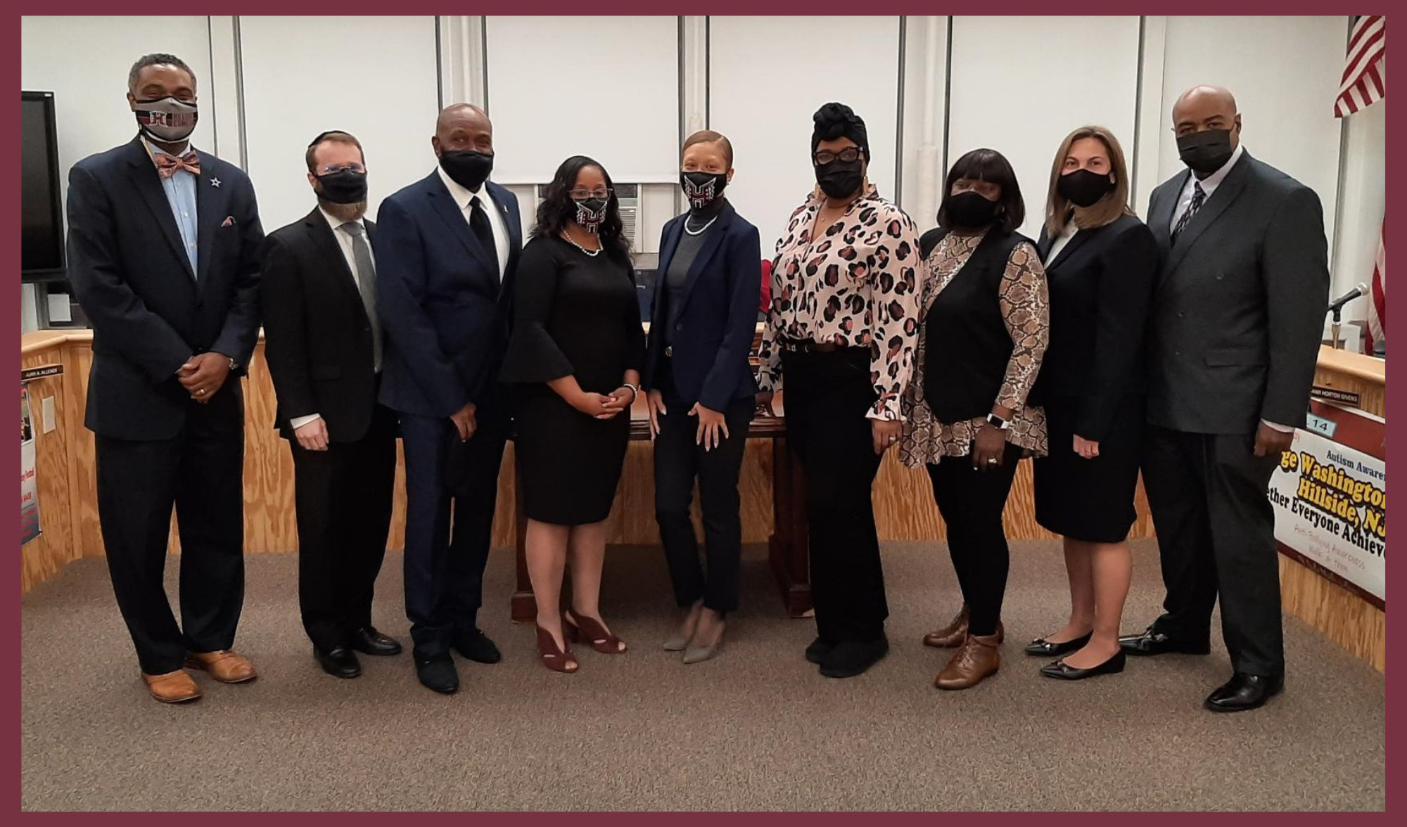 Board members standing together while wearing face masks. 