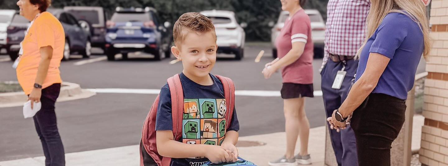 Boy entering school on first day