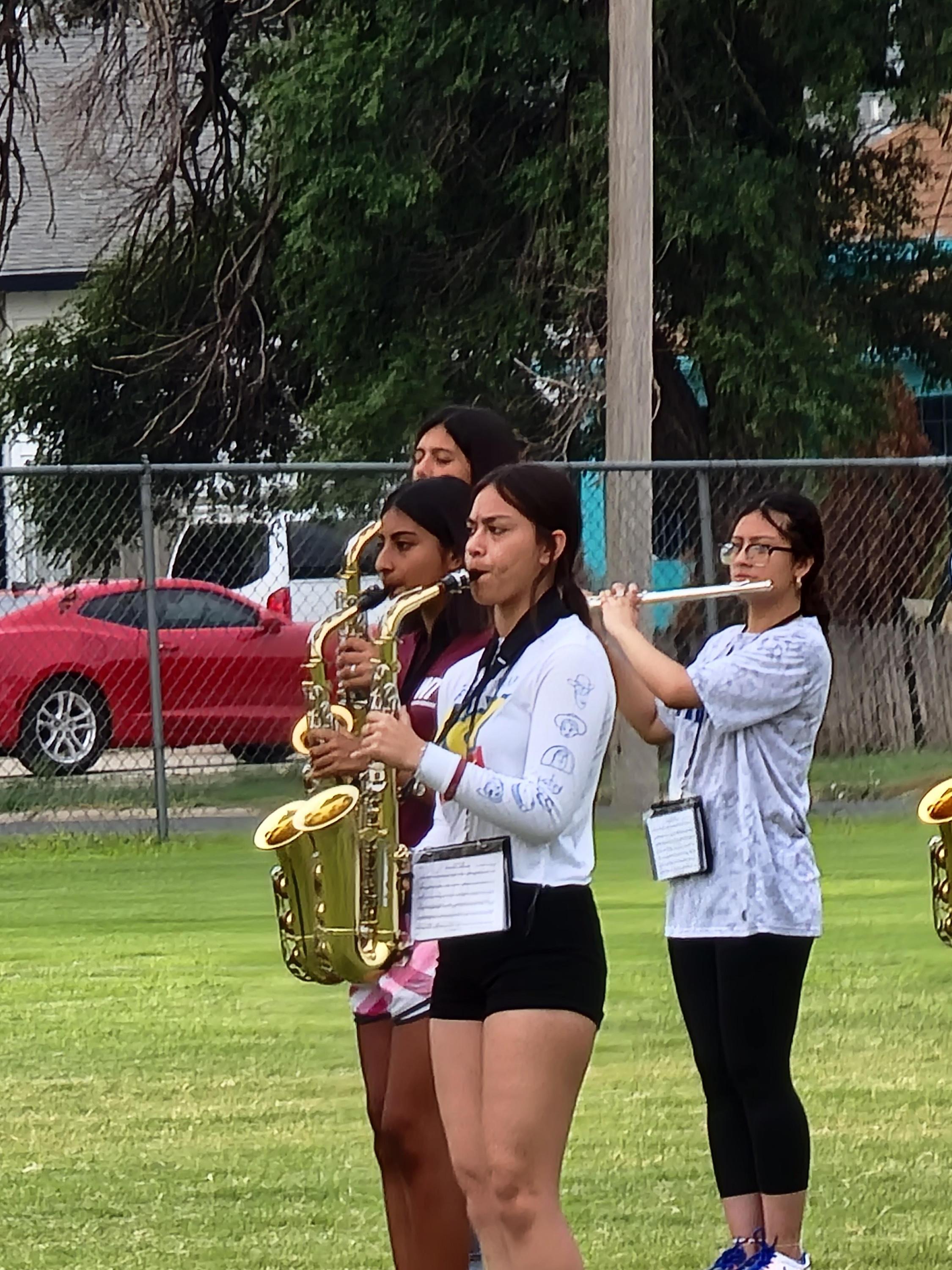 girls playing saxophone