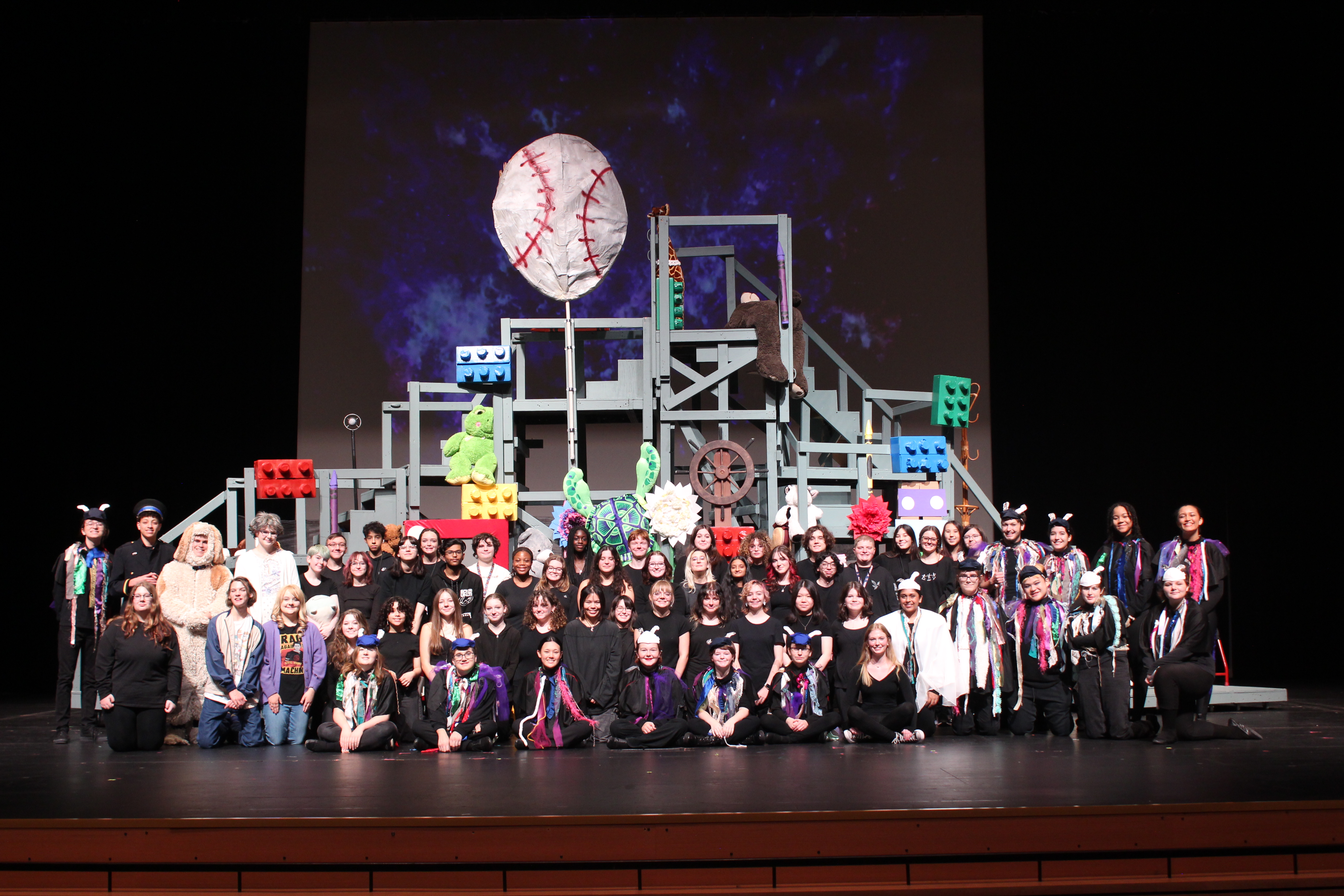 Gossamer cast and crew photo on stage.