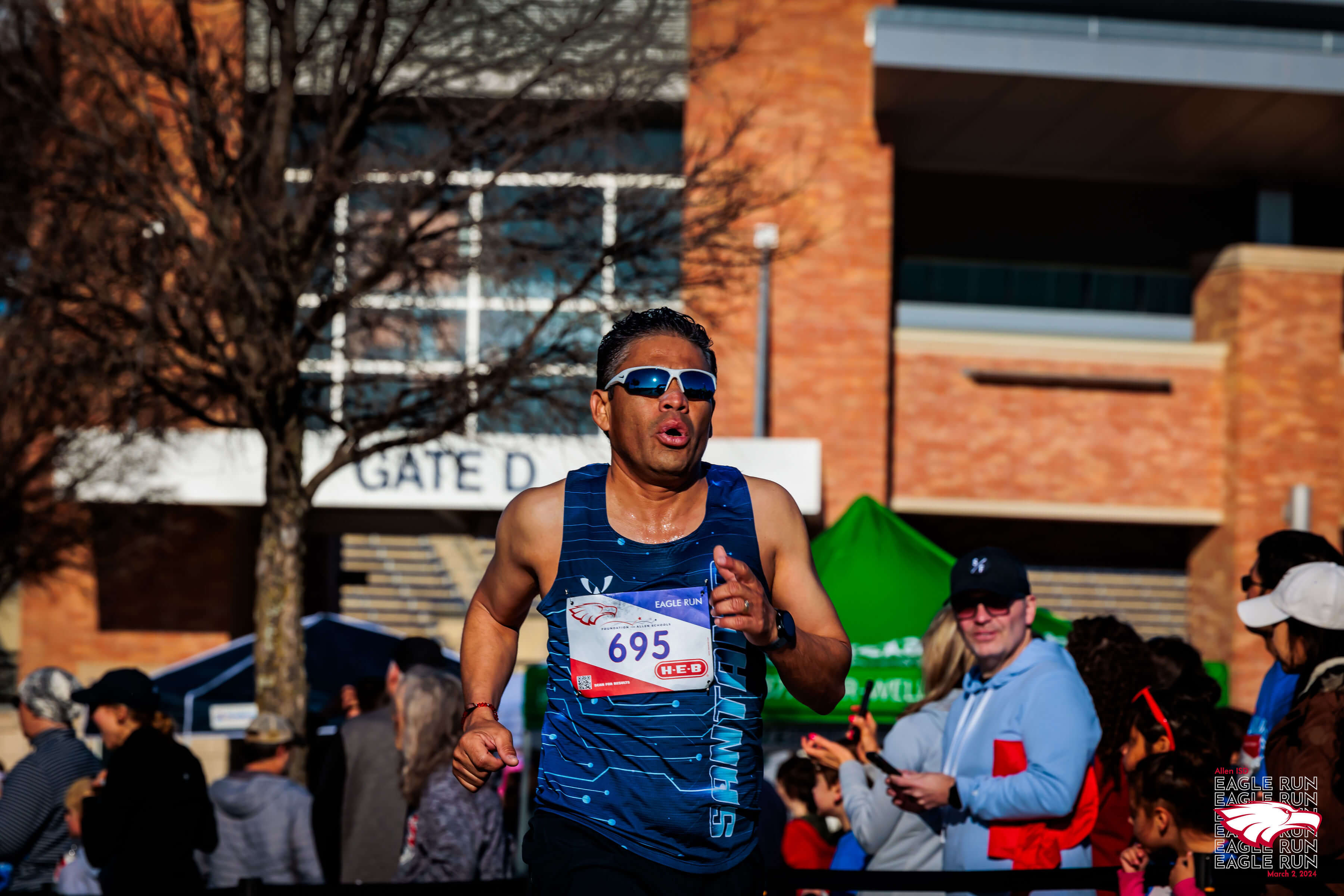 Race participants take picture using large cardboard frame