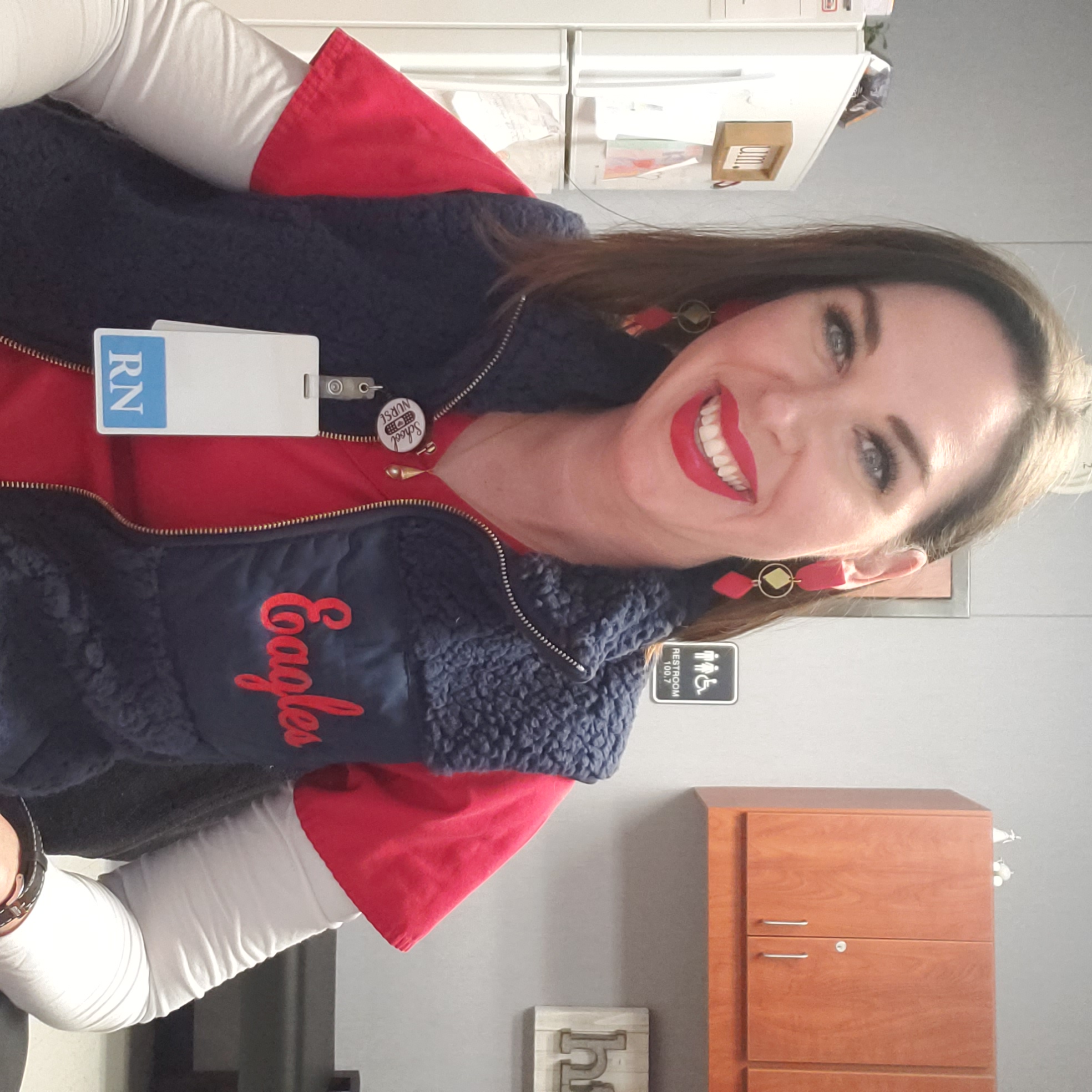 Nurse Kat with her ID badge, smiling in the clinic