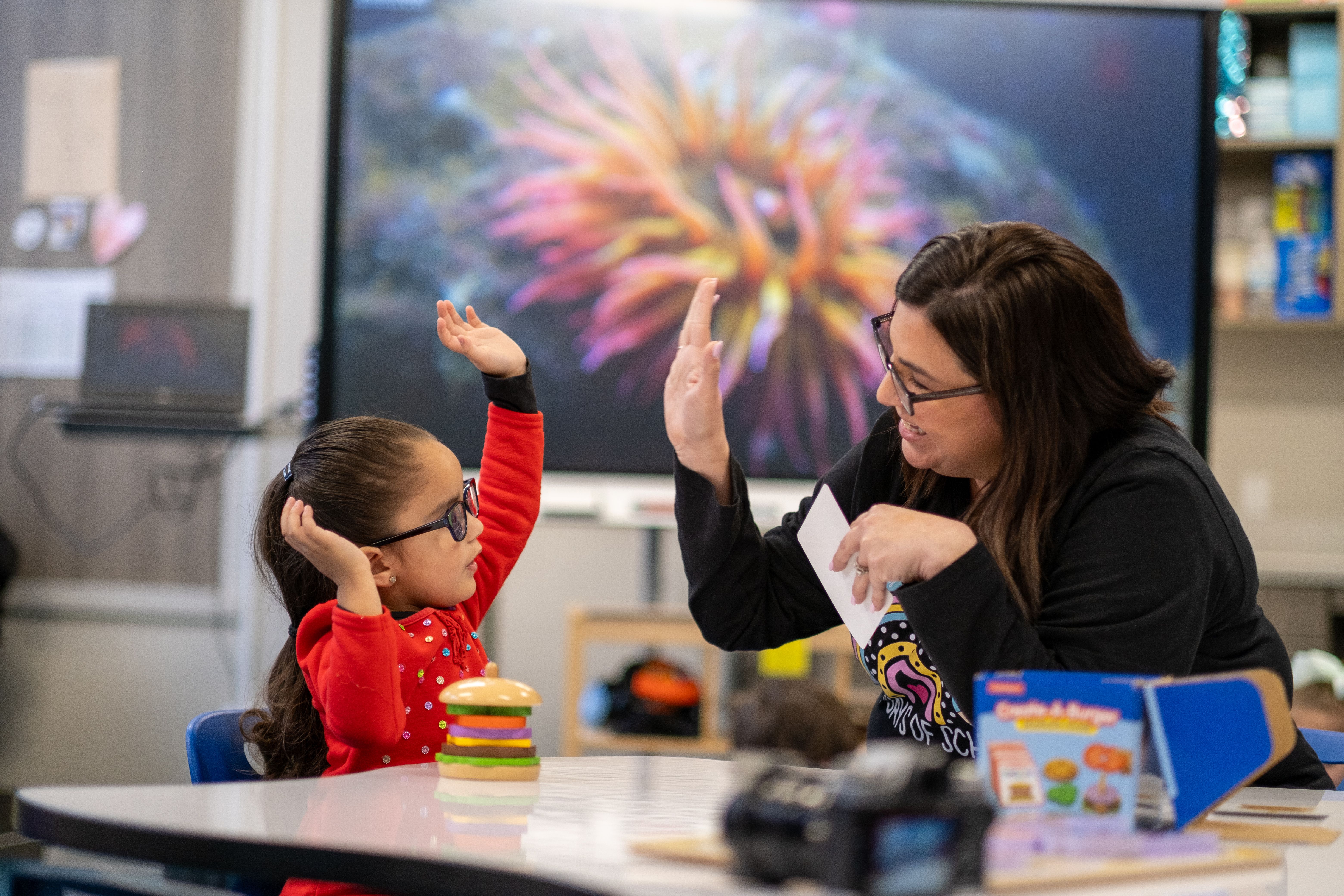 Teacher hi5 with student