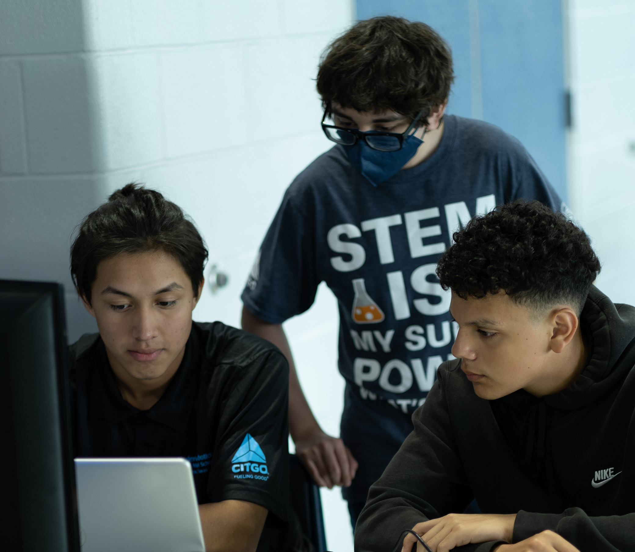 Three young students working on a project