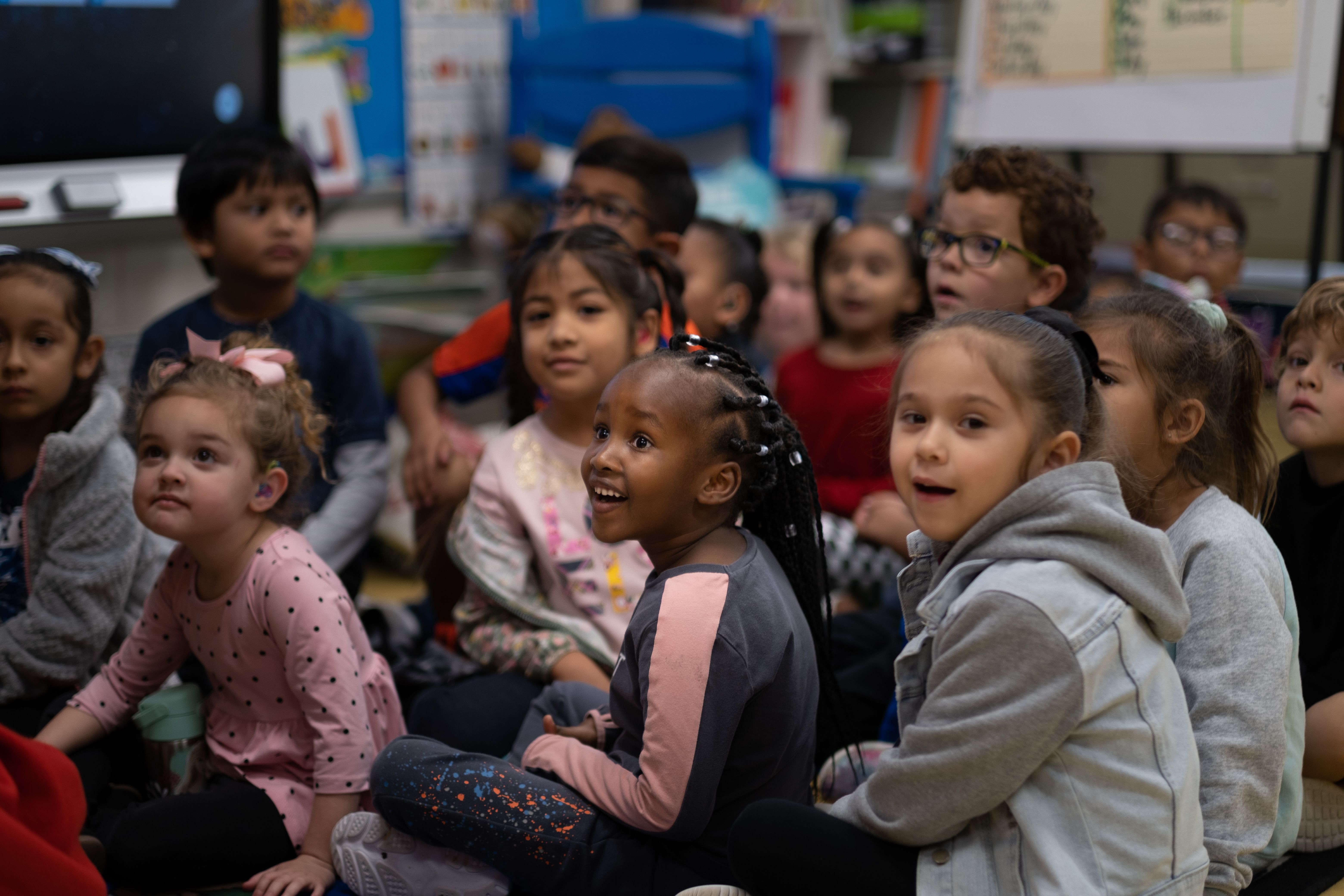 Students sitting on classroom floor