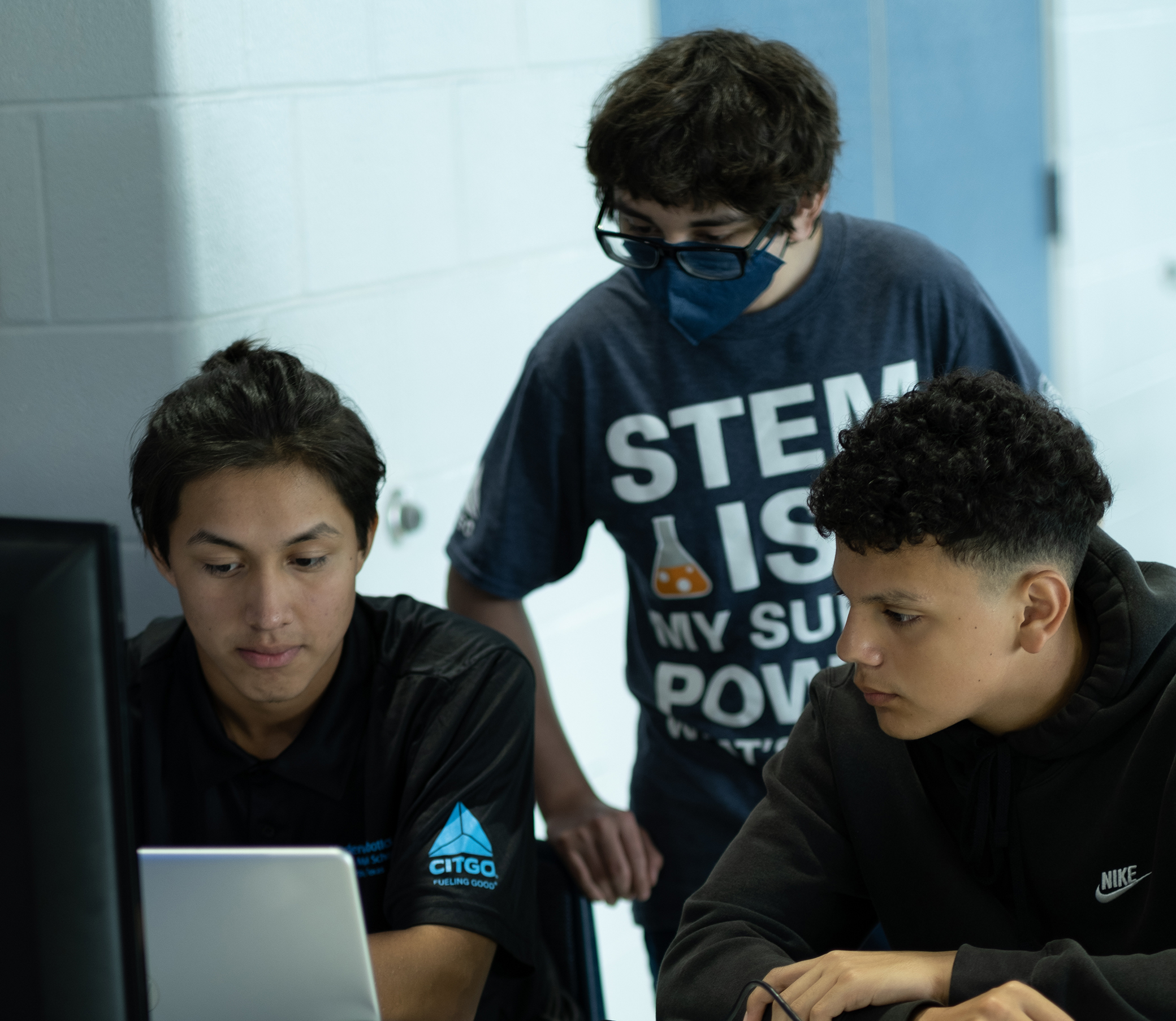 Three young students working on a project