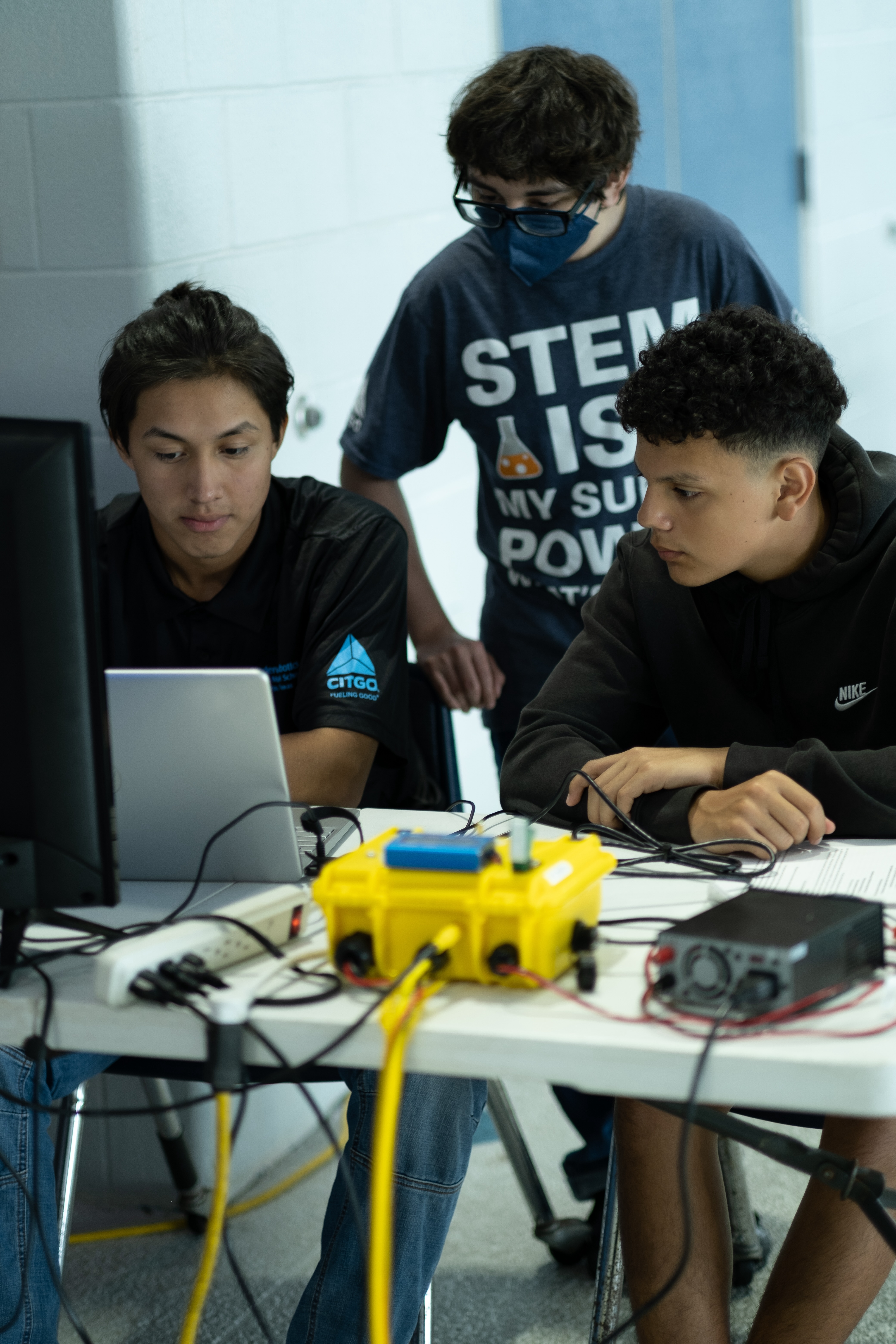 3 Male Students watching a computer