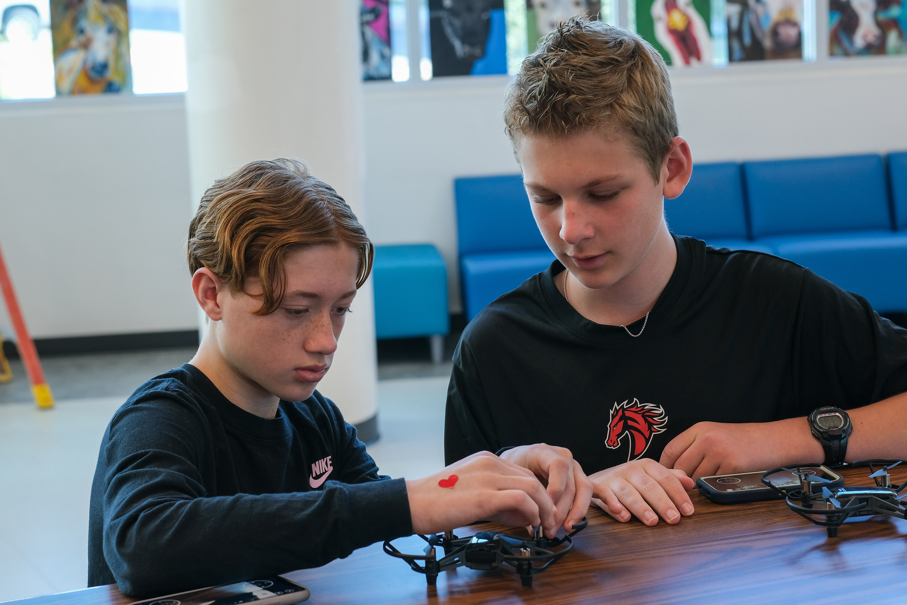 Older boy helping youger boy at school