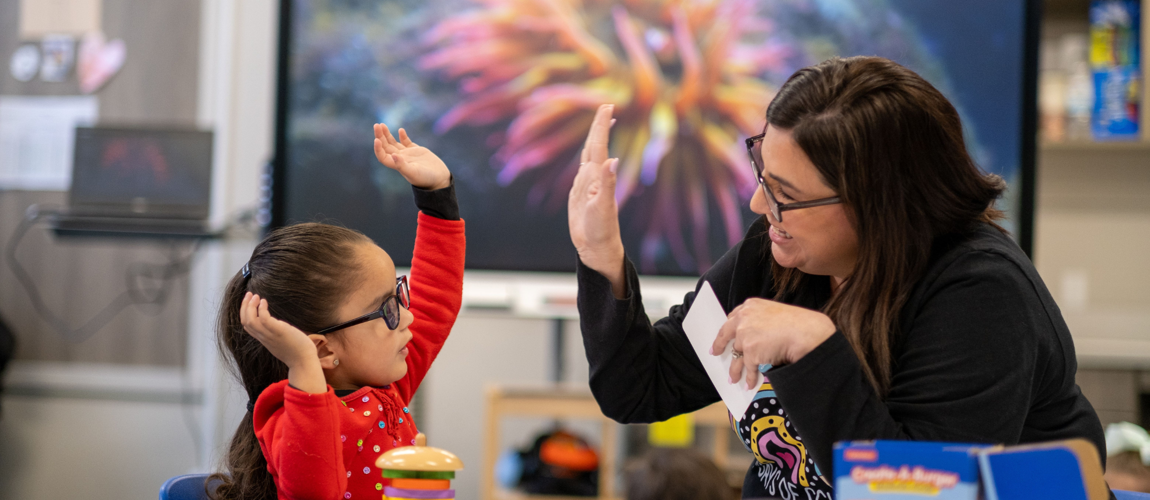 Principal and student high fiving