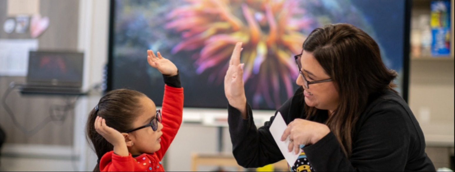 teacher and student high fiving