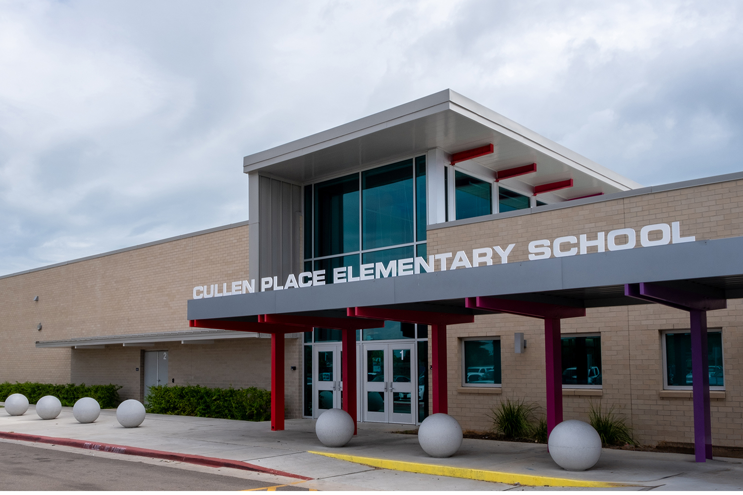 Exterior of school with vehicles