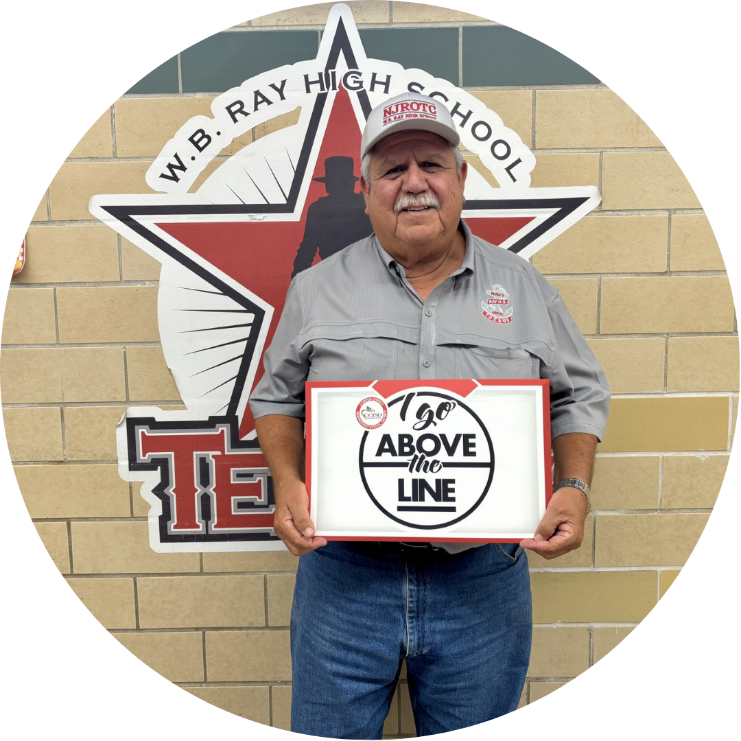 An older man in a gray shirt and jeans holds a sign reading "100 ABOVE the LINE" in front of a red star.