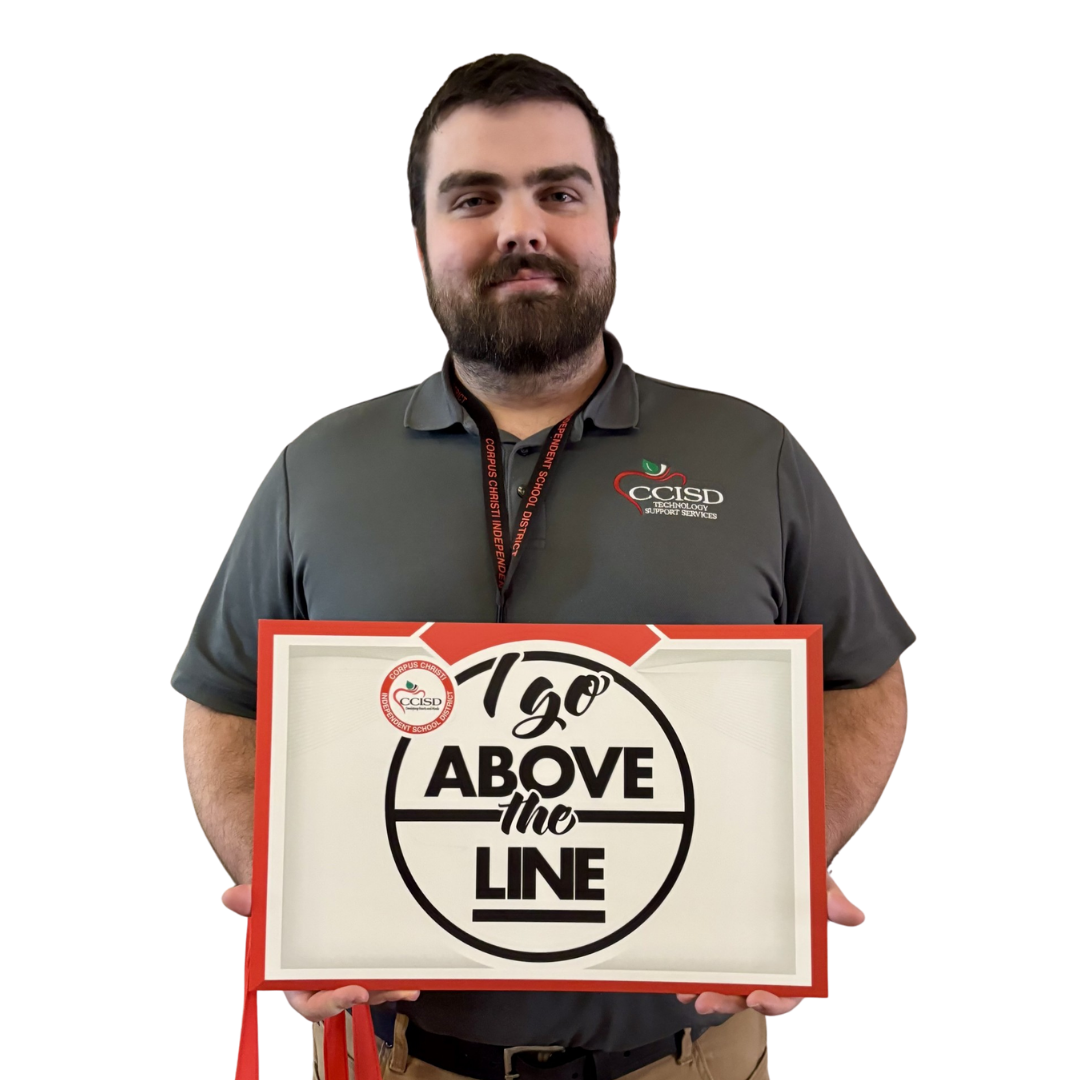 A man holds a sign with "1go ABOVE the LINE" and a logo. He wears a gray shirt, beard, ID, belt, and pants.