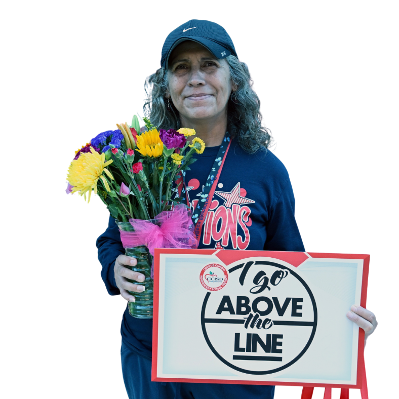 A person holds a bouquet of colorful flowers and a sign reading "120 Above the Line". The person is wearing a cap and a blue sweatshirt.