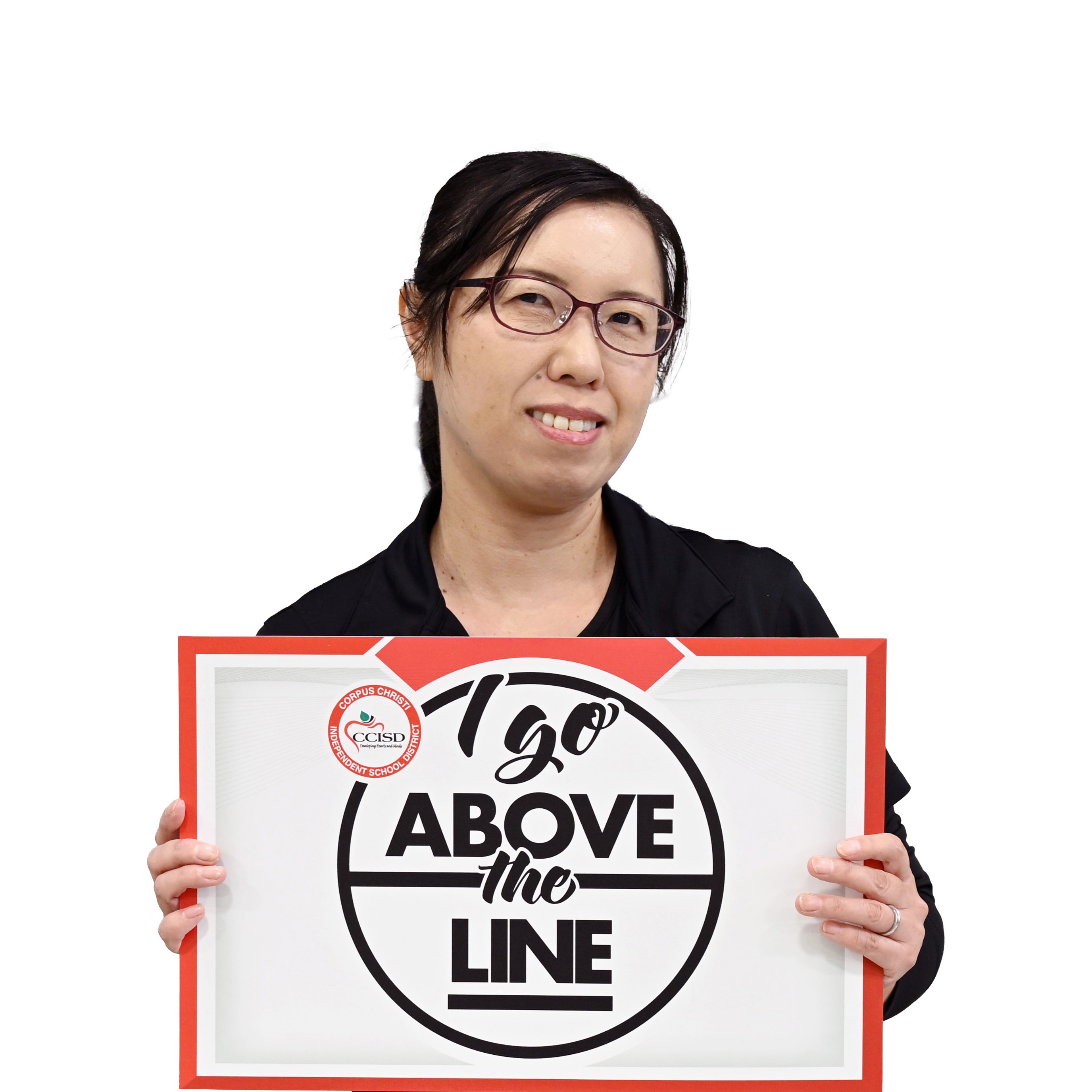 Woman with glasses holding a framed sign with "I Go Above the Line" text.