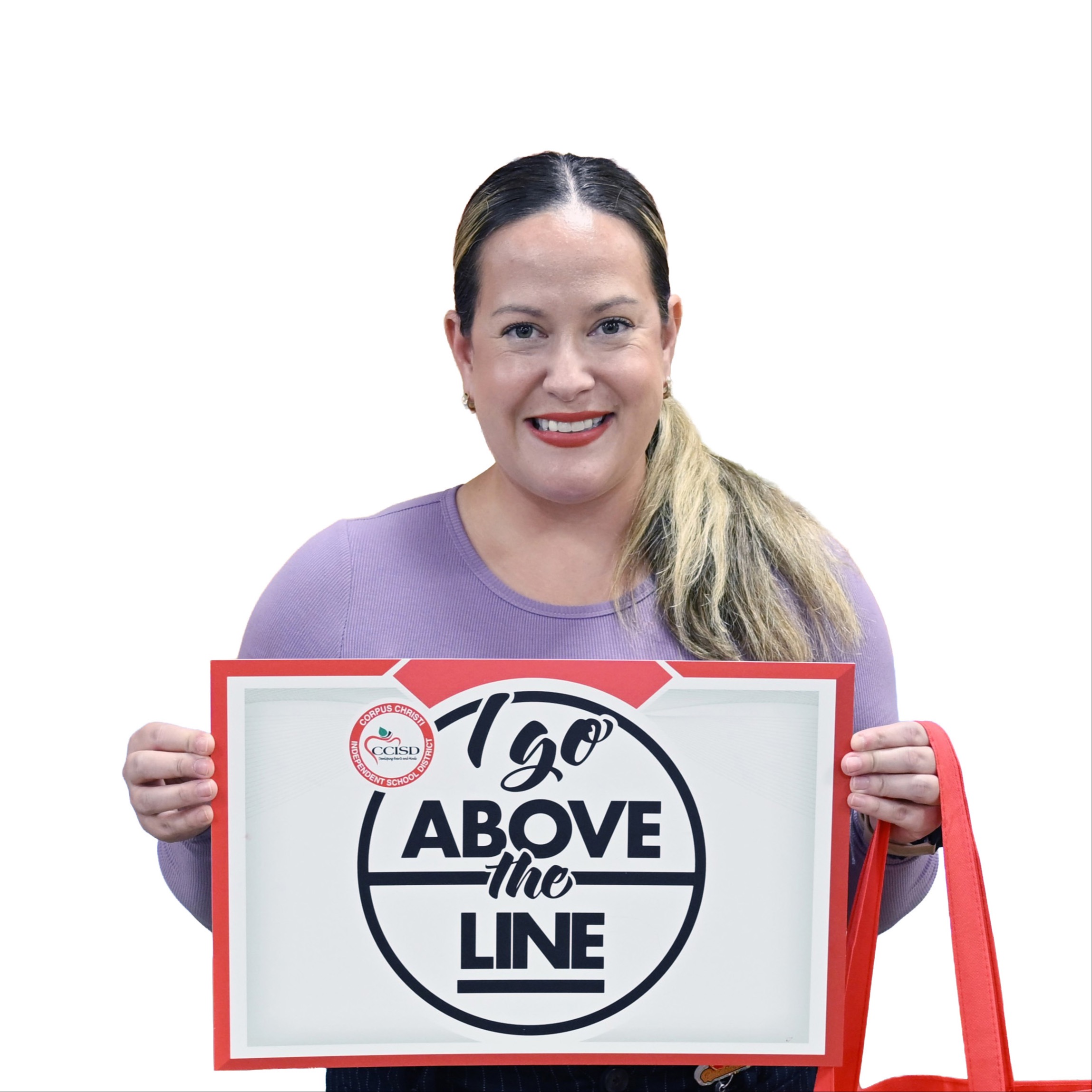 A woman holds a white sign saying "I go above the line" in front of her chest.