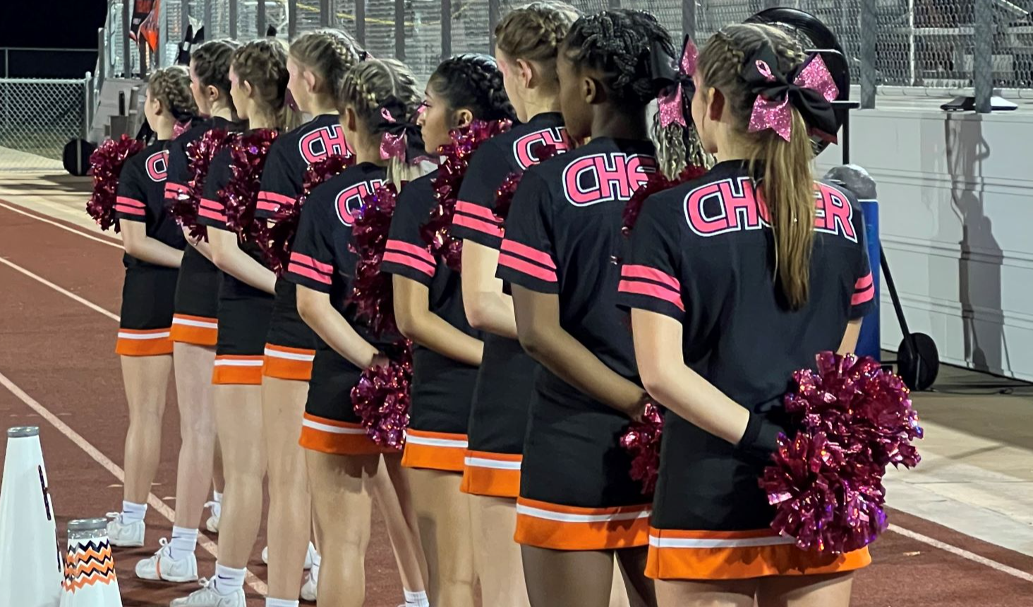 cheerleaders standing in line for national anthem