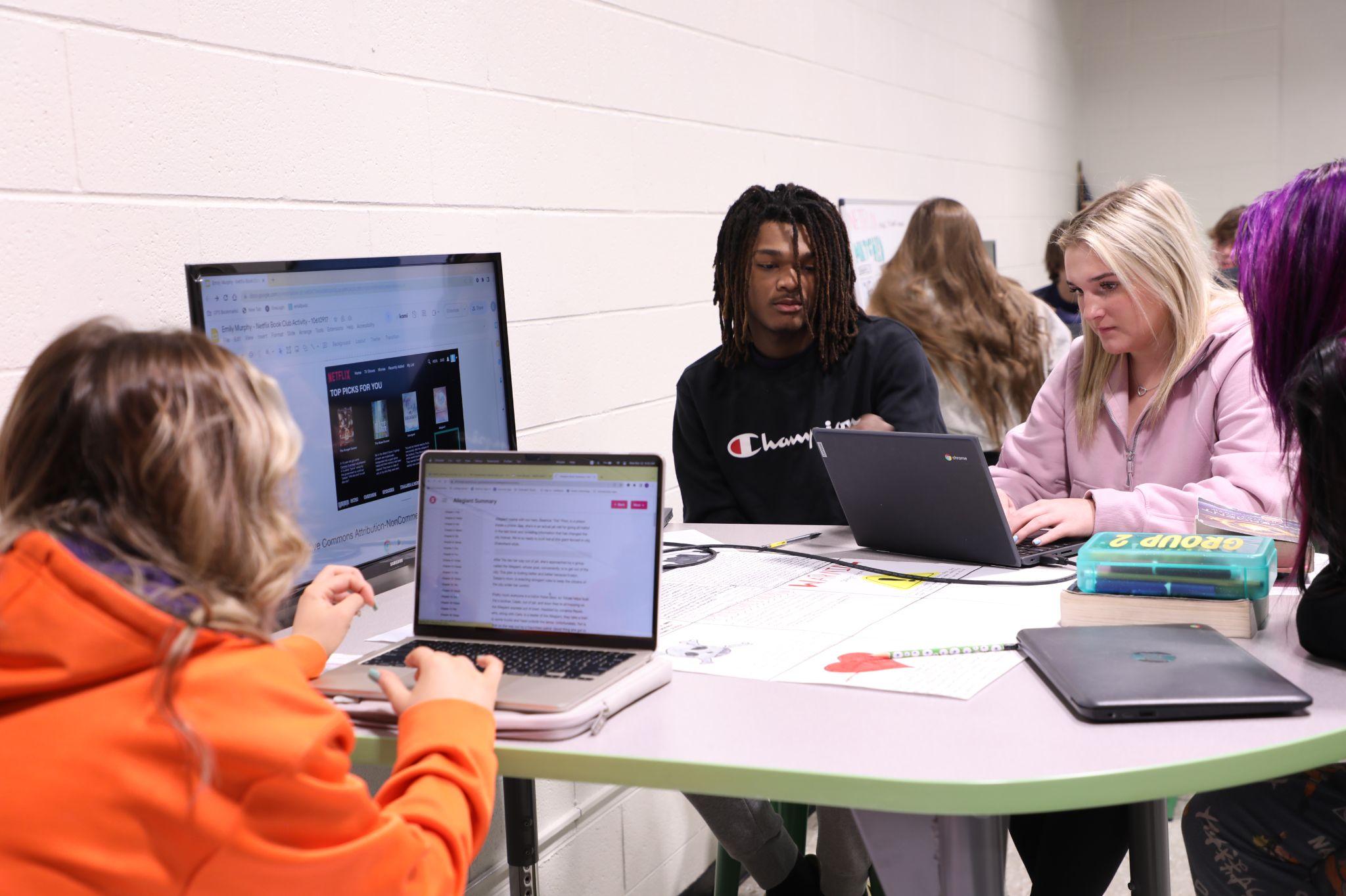 High school students collaborate on an assignment using their chromebooks.