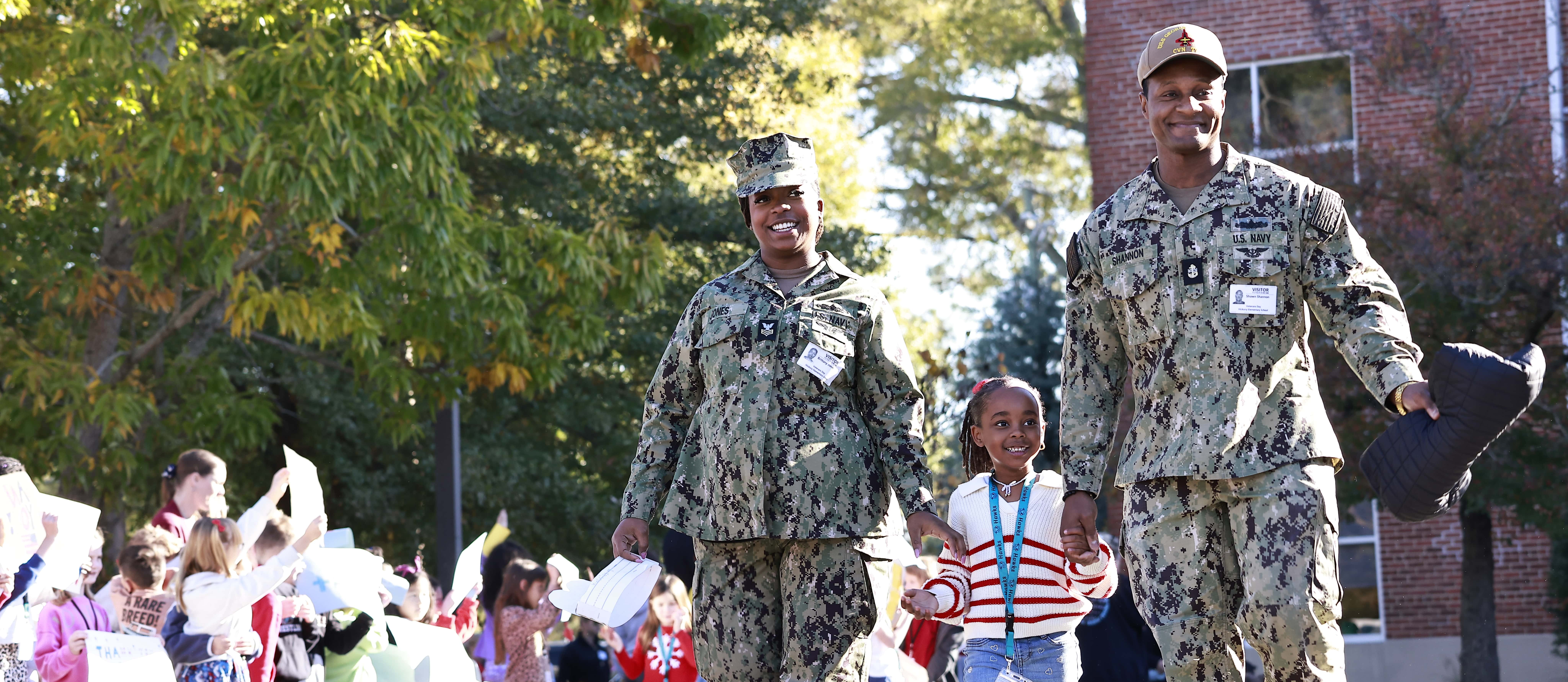 A family walks during the Hickory Elementary Veterans Day parade