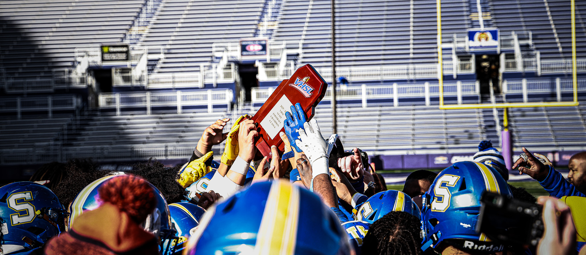 The Oscar Smith High School football team celebrates after winning the VHSL State Championship