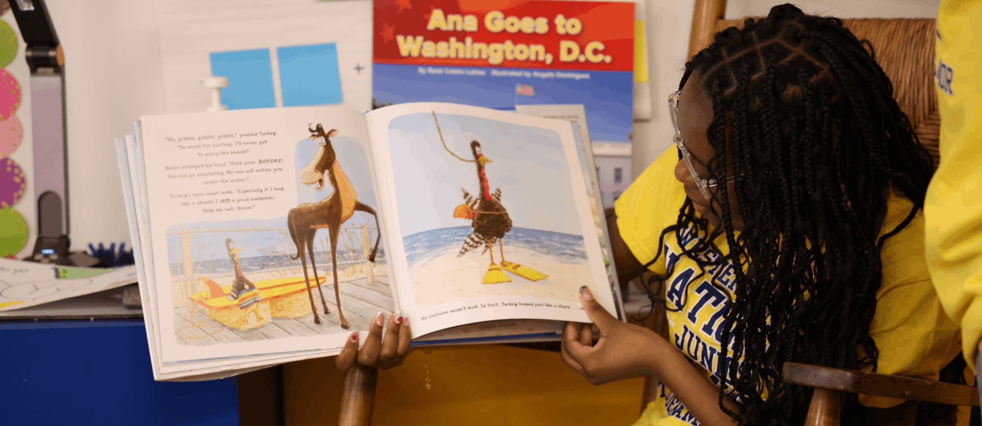 A Western Branch Middle students reads to a group of Western Branch Primary students