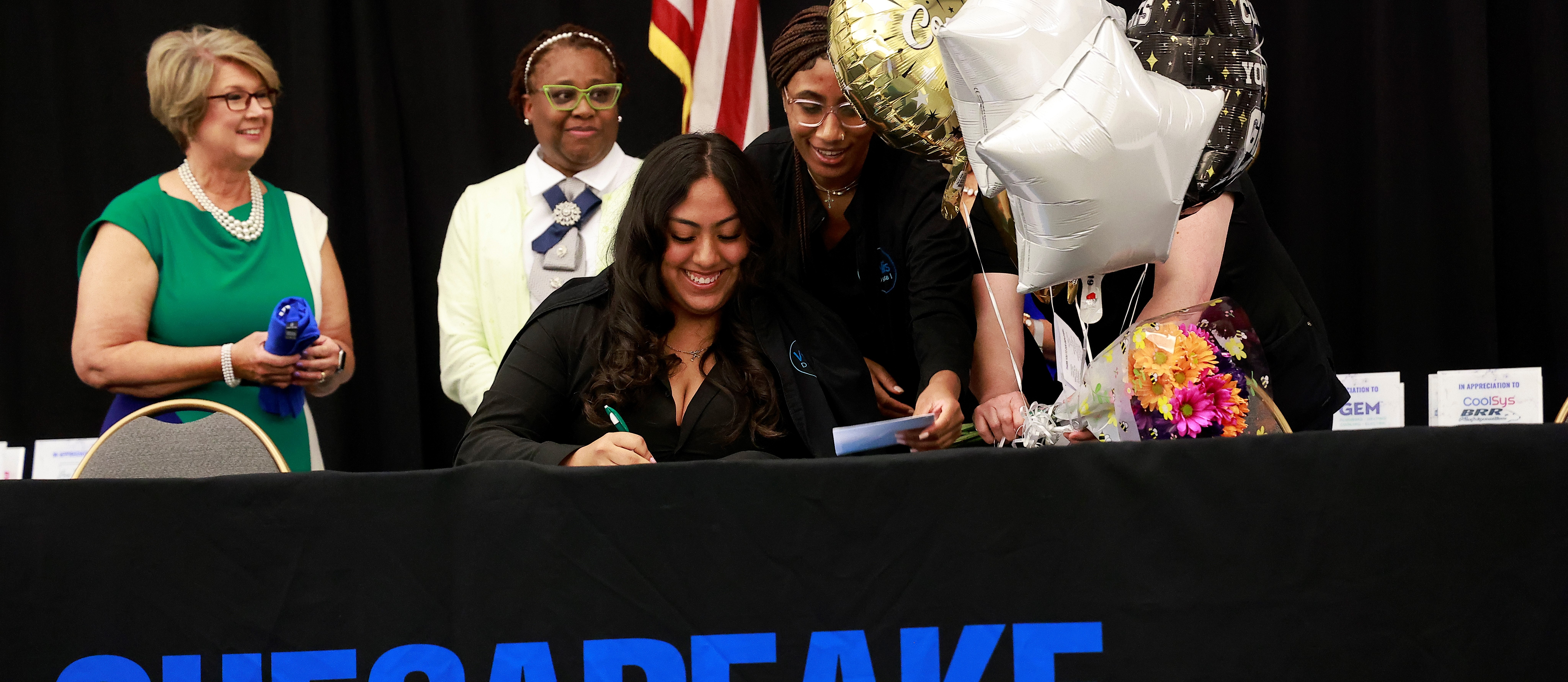 A CCC student signs her letter of intent