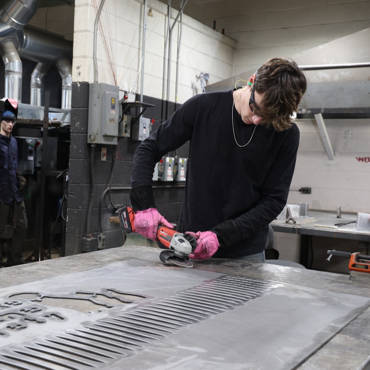 A welding student works on a project in the CCC welding studio.