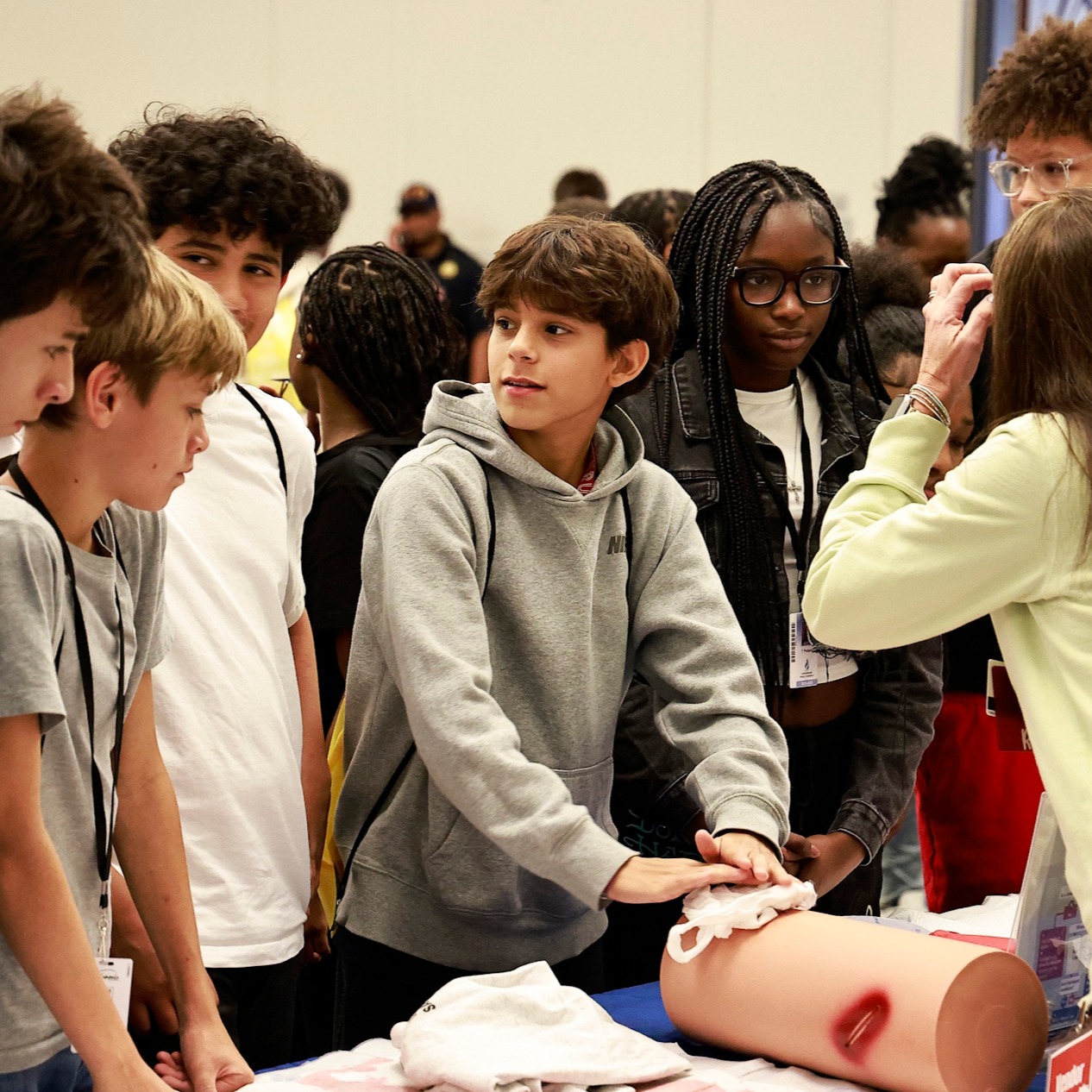 Middle students attending the World Of Wonder expo participate in a medical services presentation.