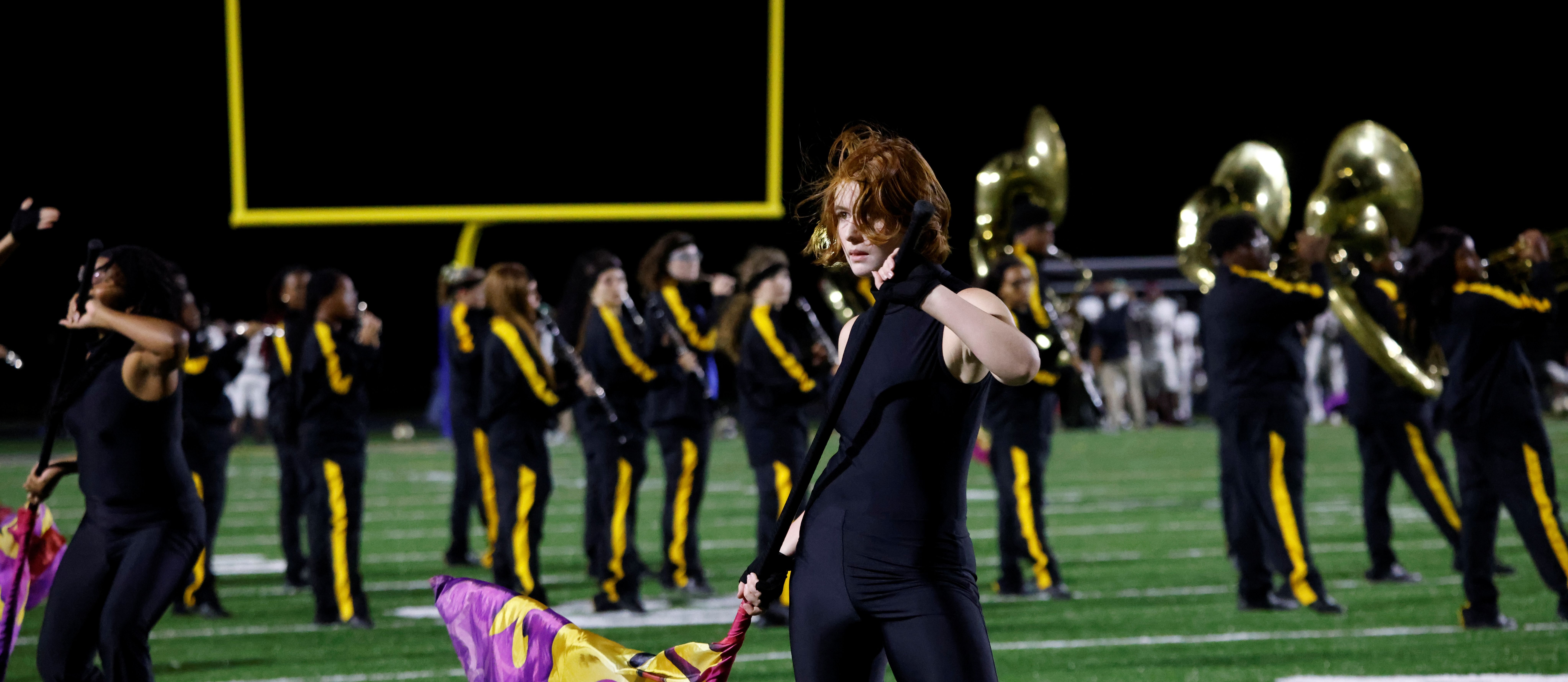 A member of the OSHS color guard performs her routine during a halftime performance