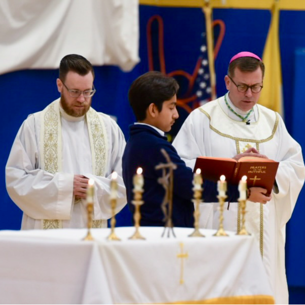 priest reading at mass