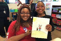 teacher with elementary student holding award 