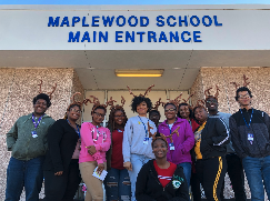 students in front of high school entrance 