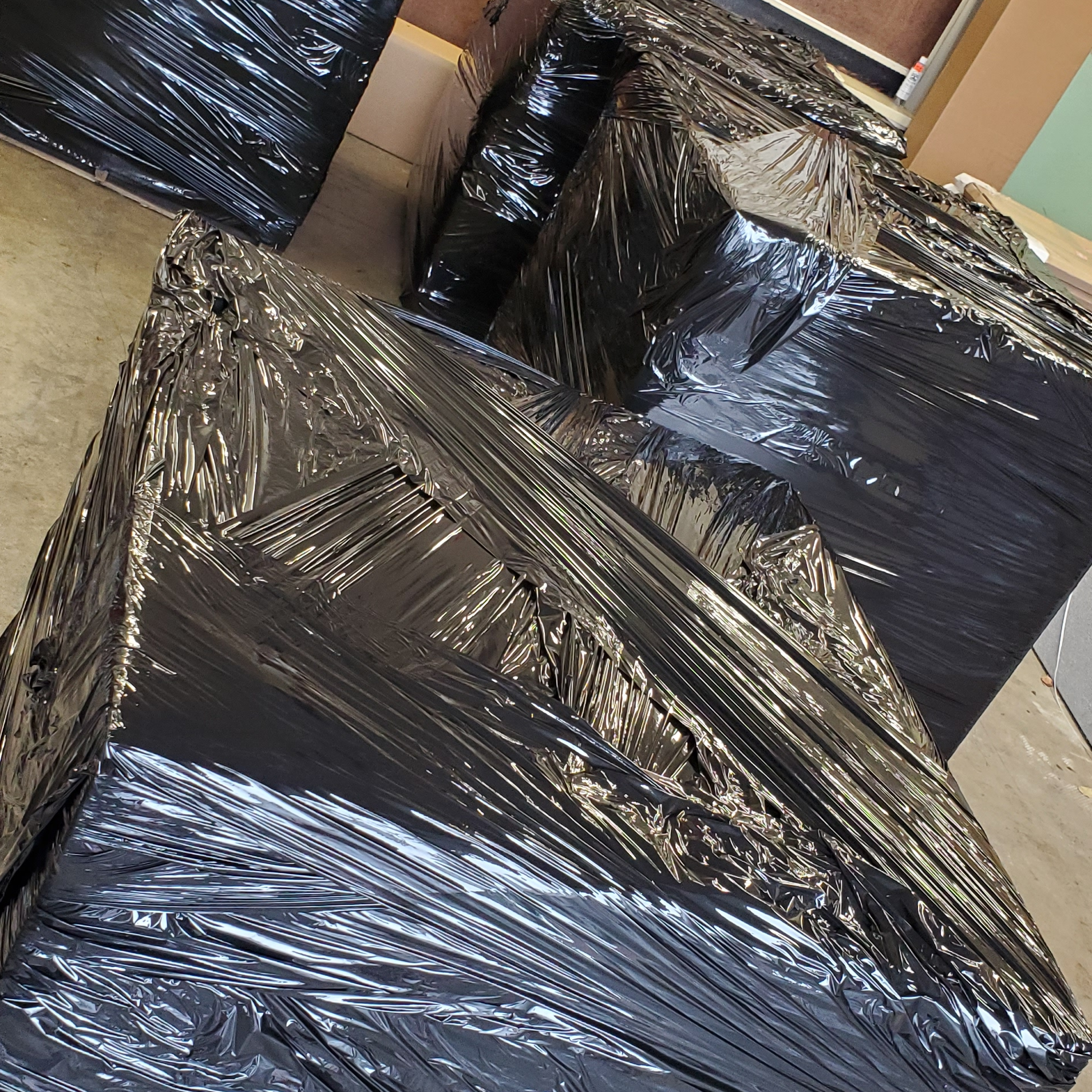 4 large pallets filled and wrapped up with black and clear wrapping.