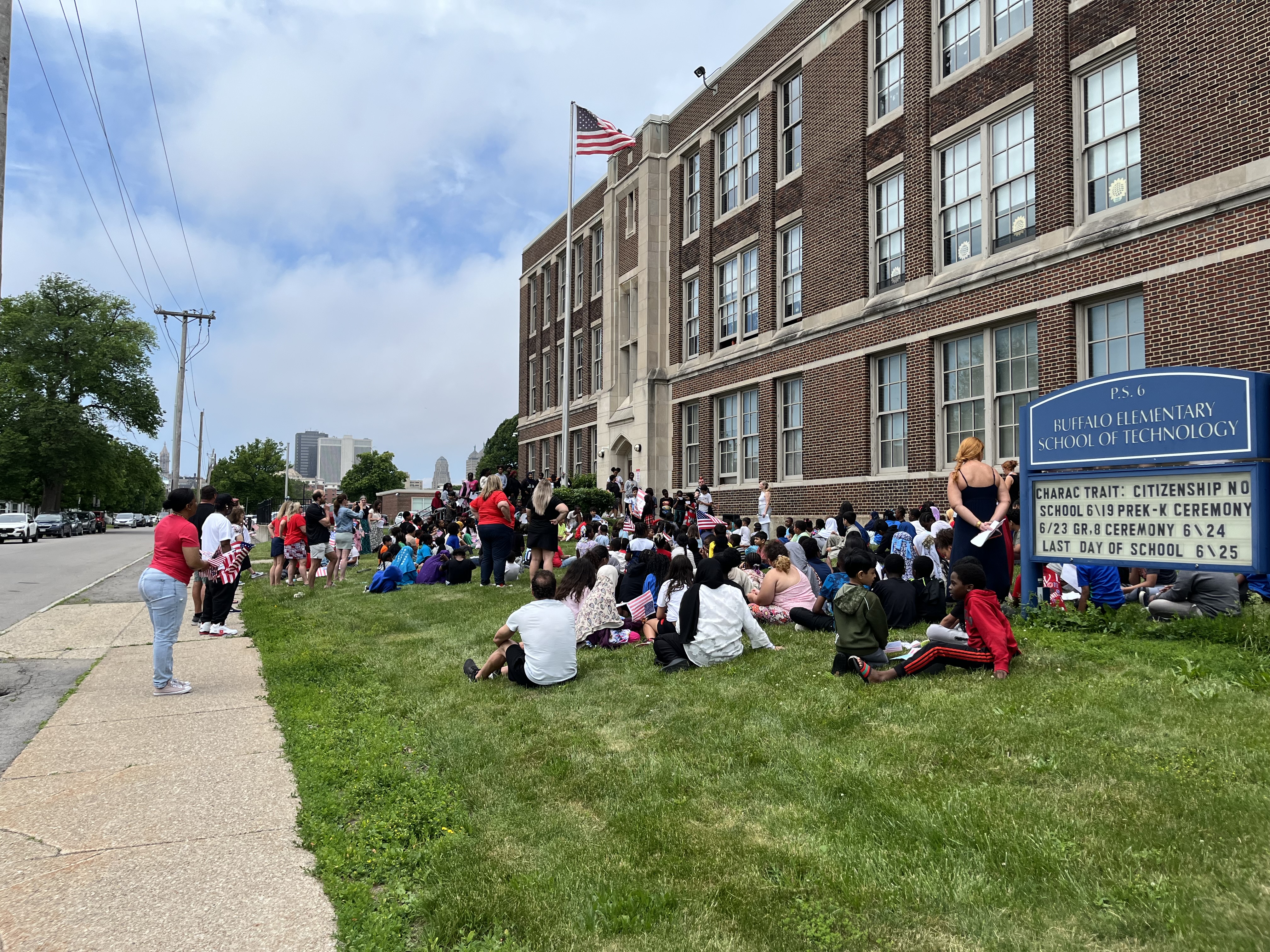 Students gathered in front of the  school for Flag Day 