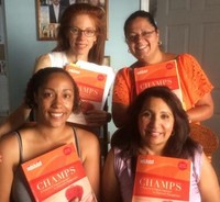 Group of teachers holding book titled 'Champs'