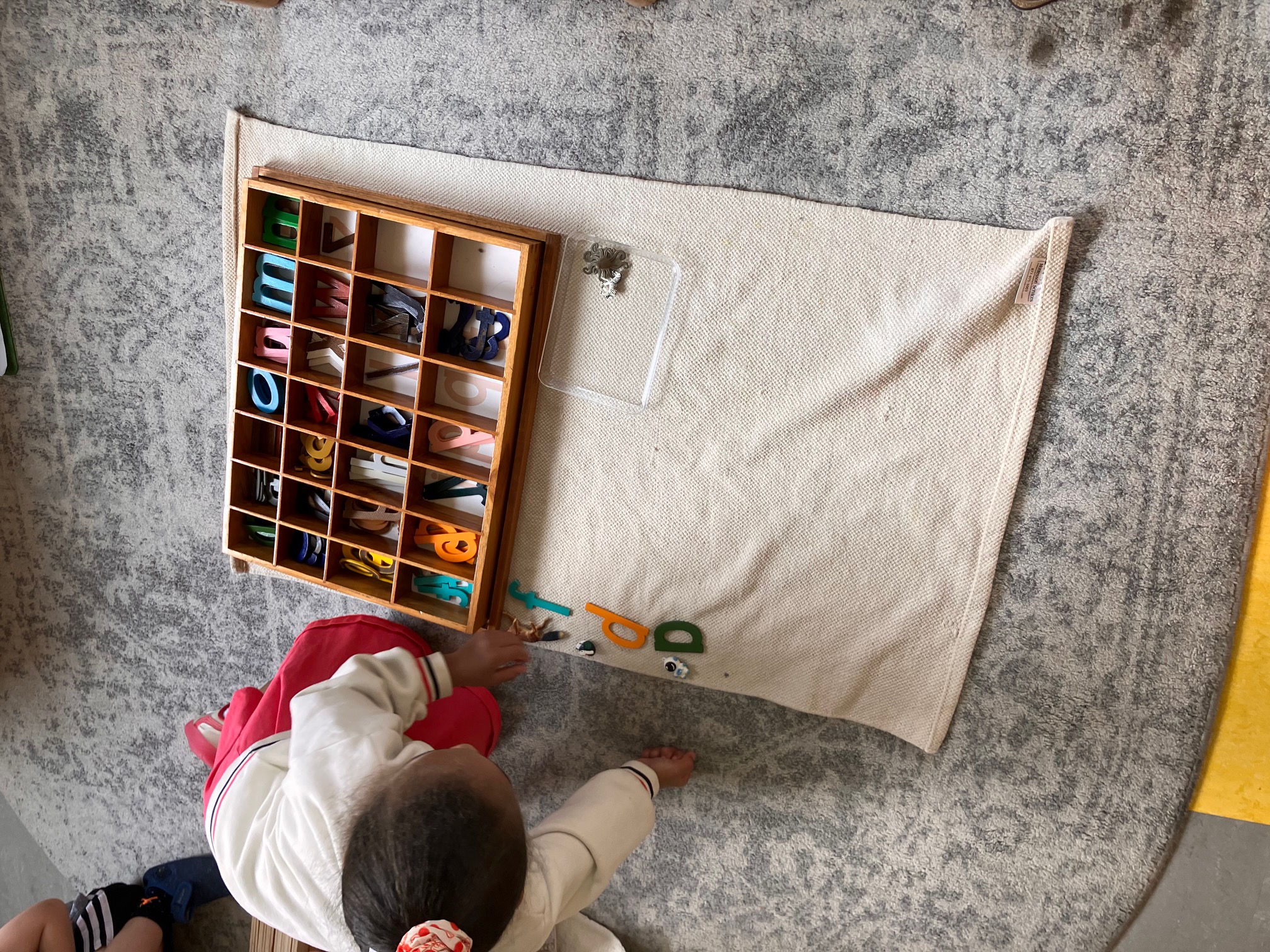 Child working with letters in a Montessori classroom