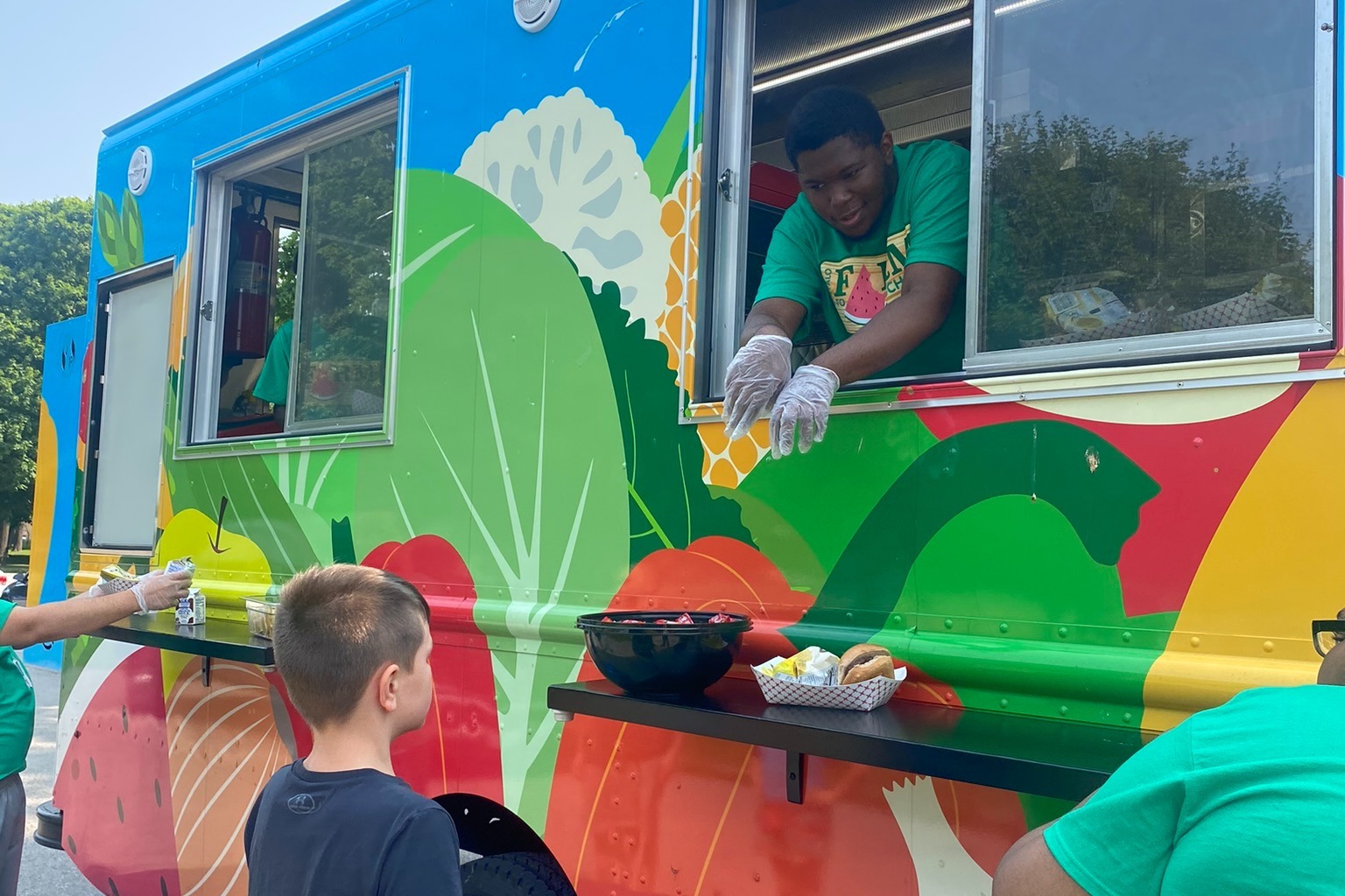 Student serving food from Food Truck