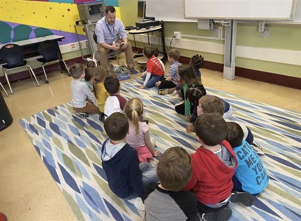 Students seated on the floor during story time