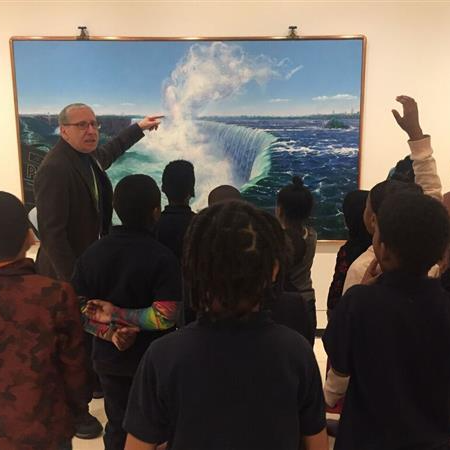students and adult looking at art