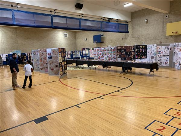 tables and posters on tables in basketball court