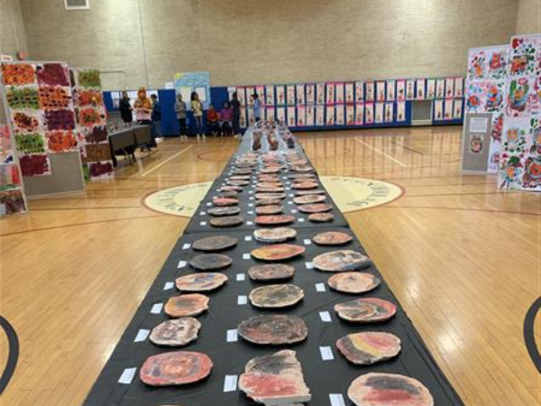 artwork laid out on table in basketball court