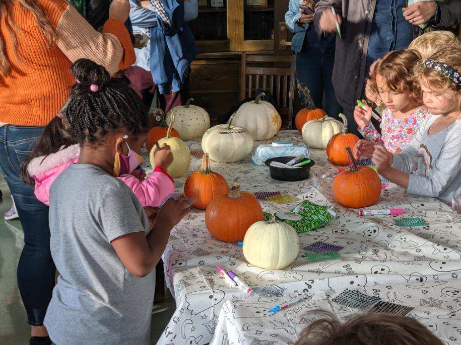 kids painting pumpkins at fall fest