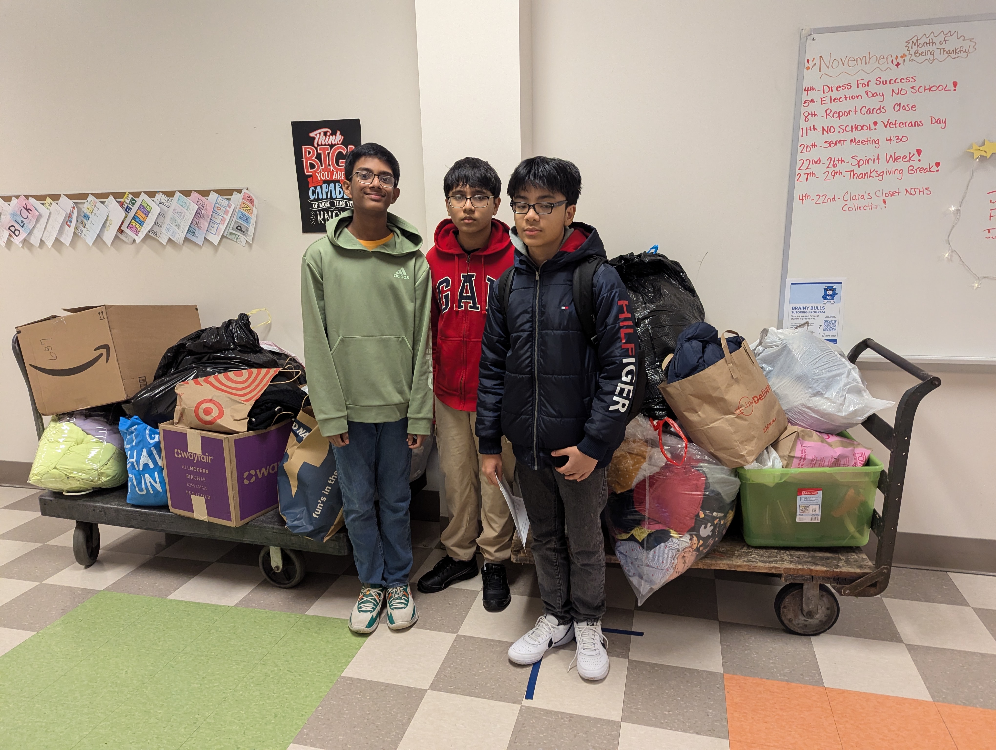 students and clothes bins