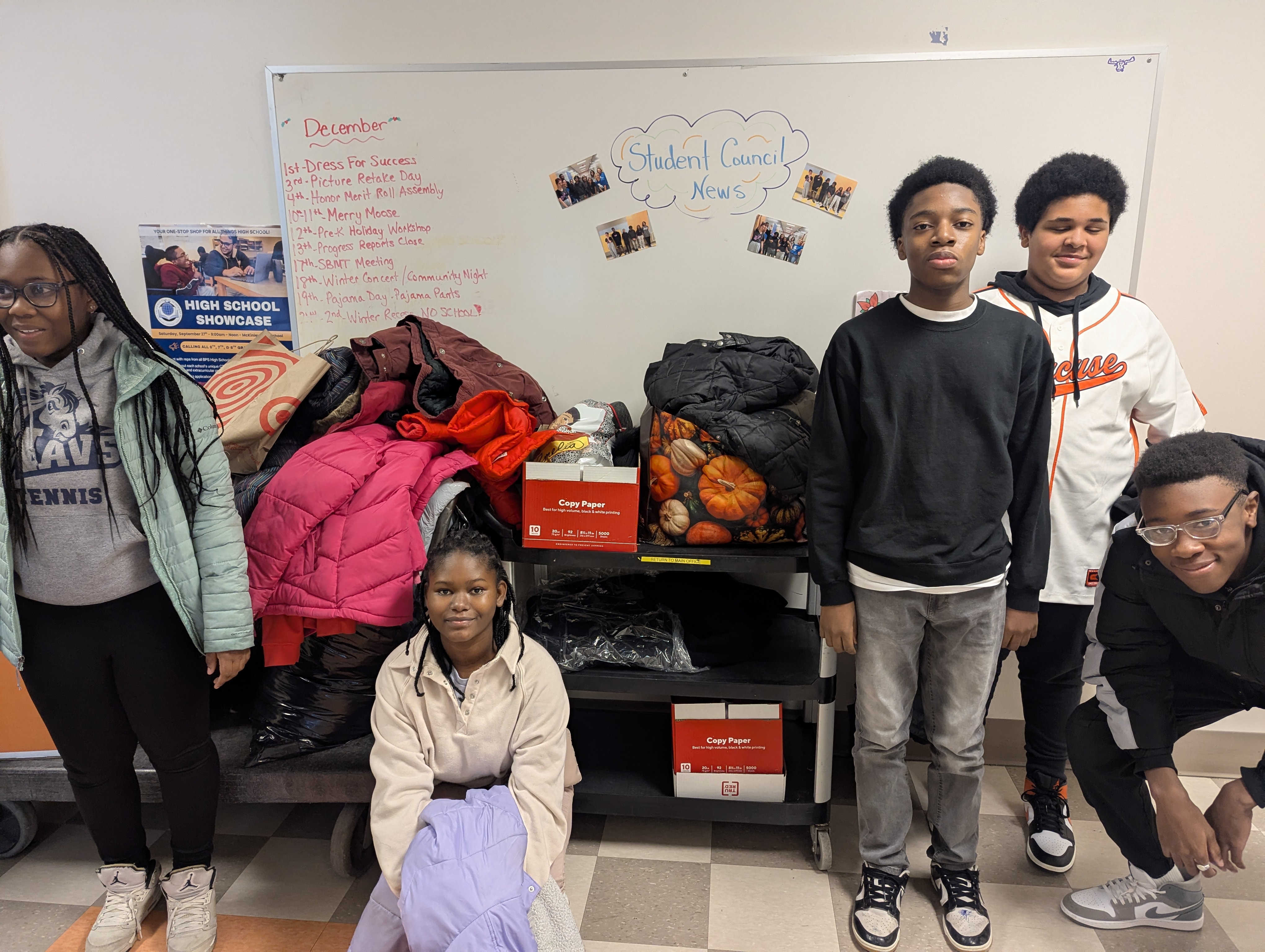students and clothes bins