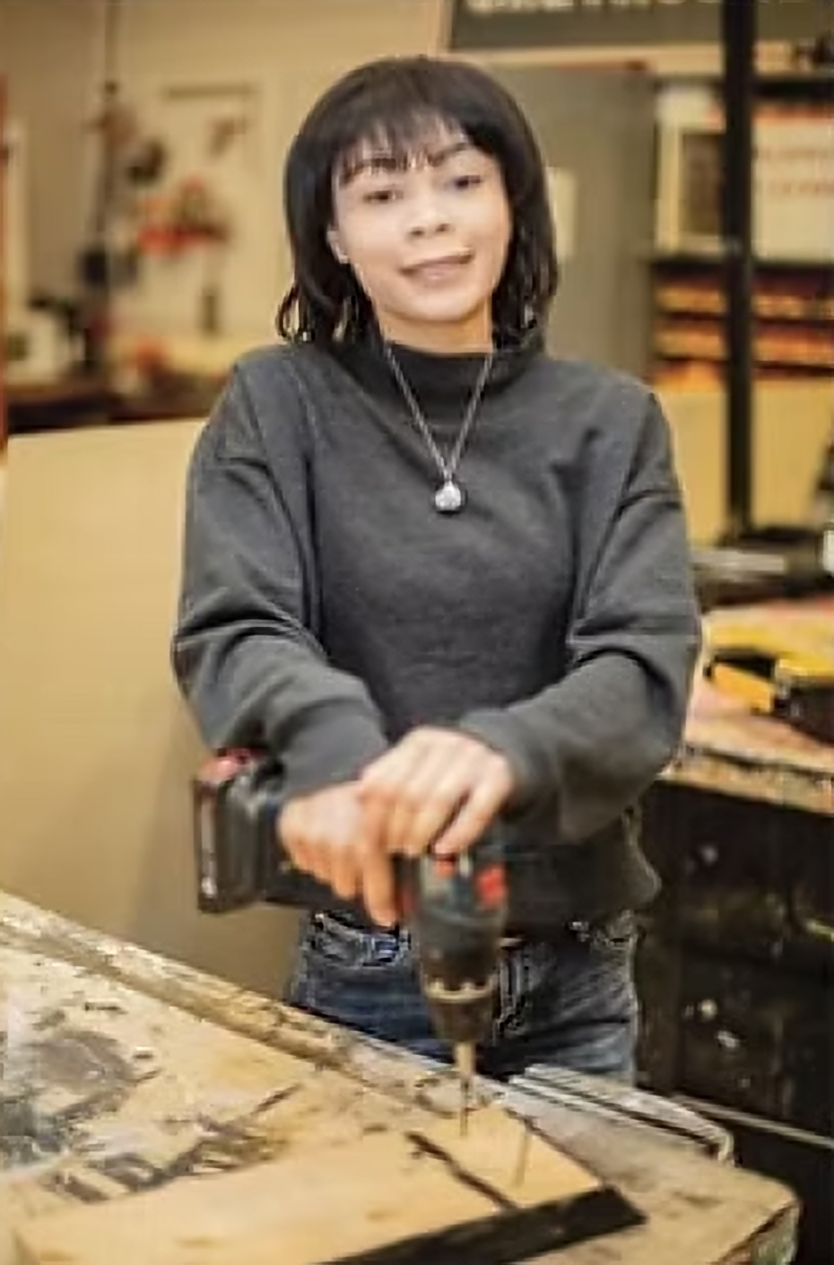 Student working with drill and wood