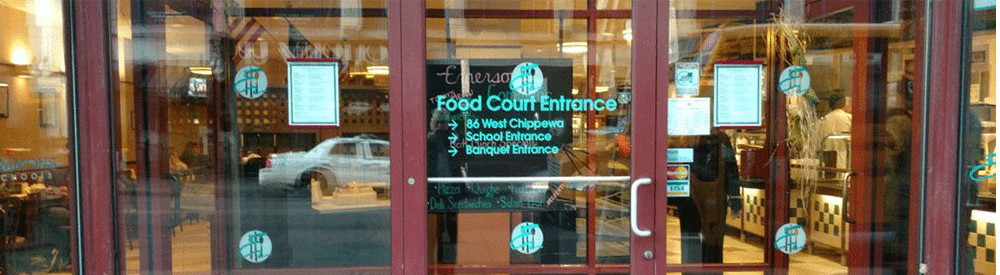 a photograph of the glass doors of the food court entrance