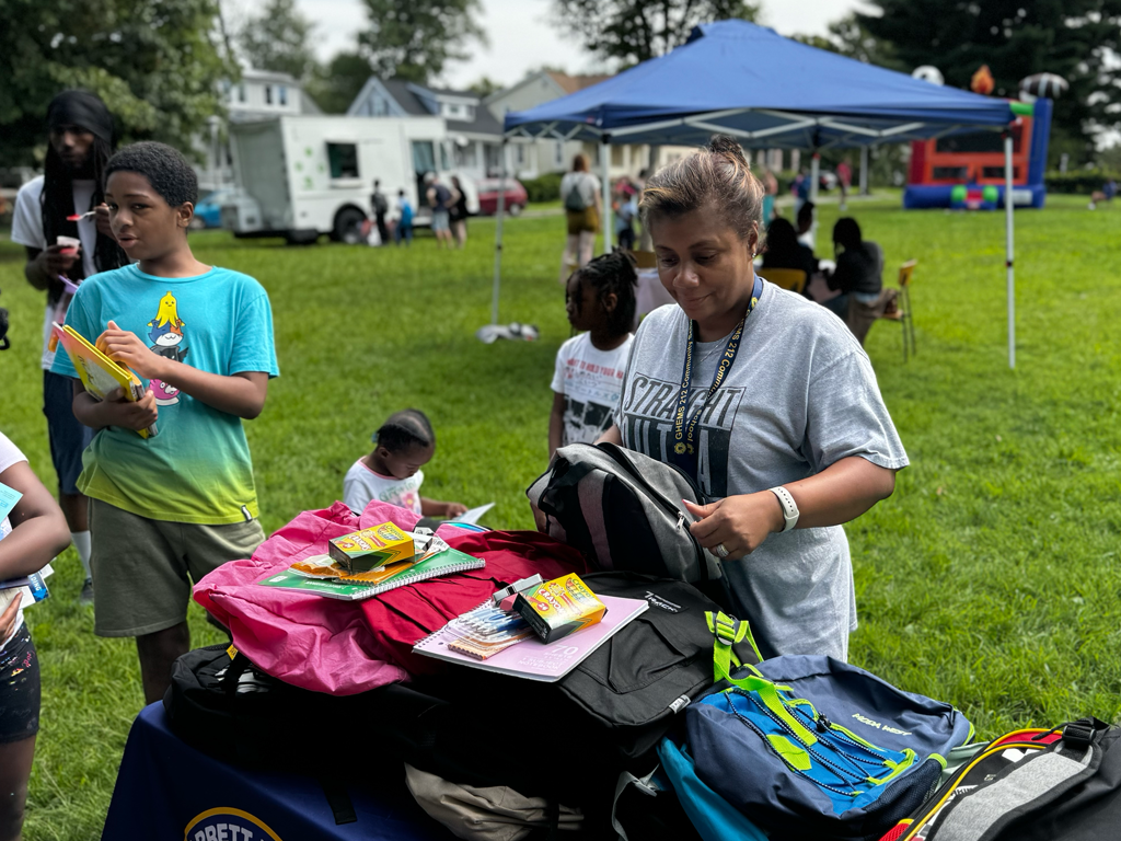 Principal giving out school supplies