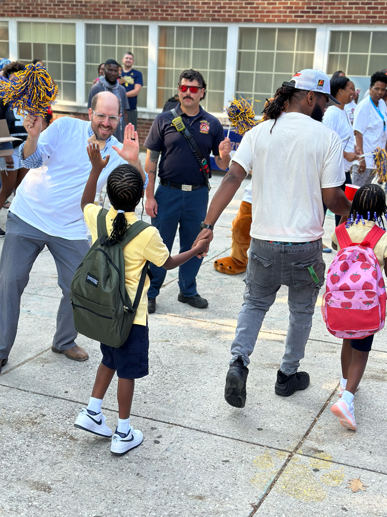 School Commissioner greeting students