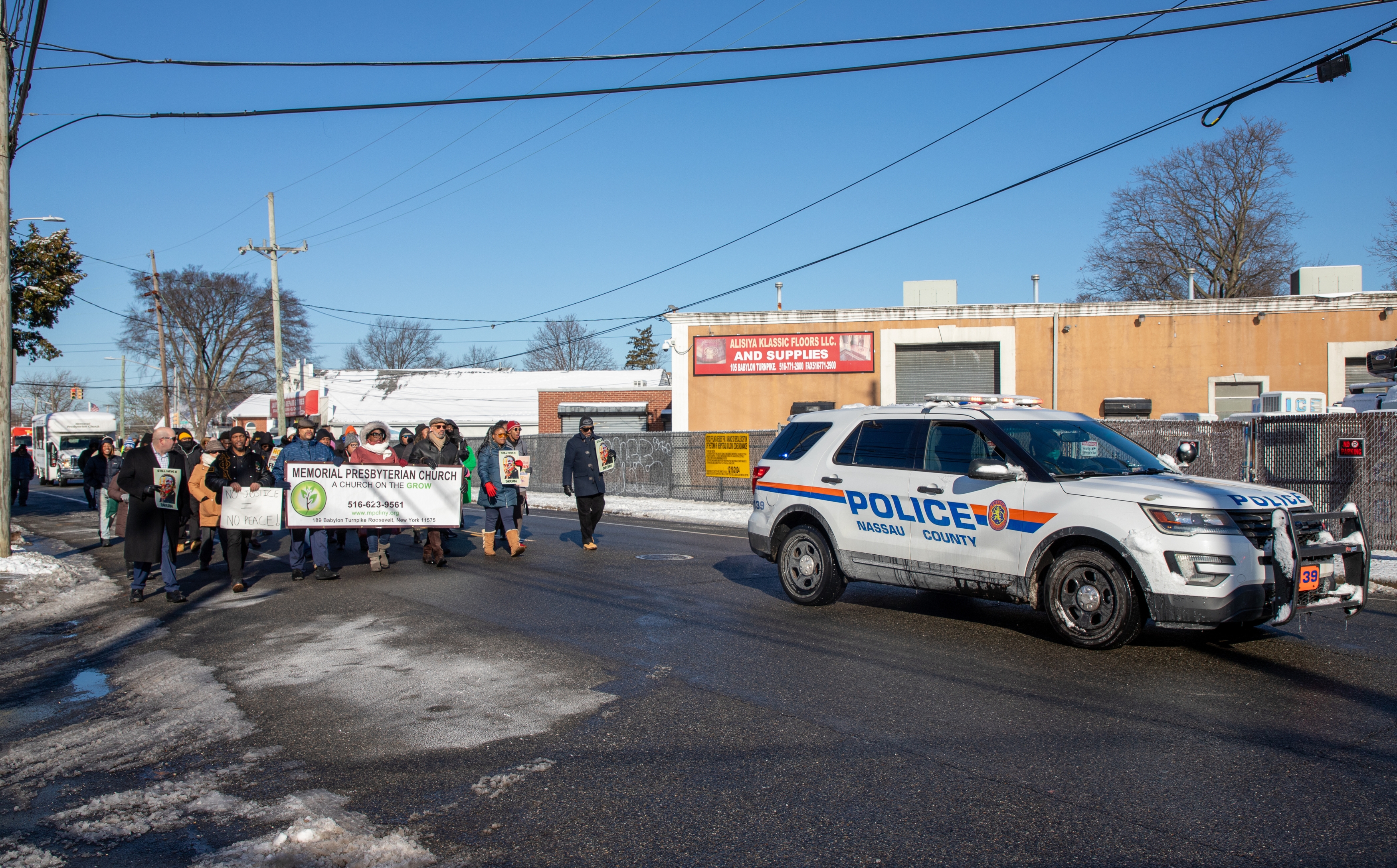 Cop car stopping traffic for march