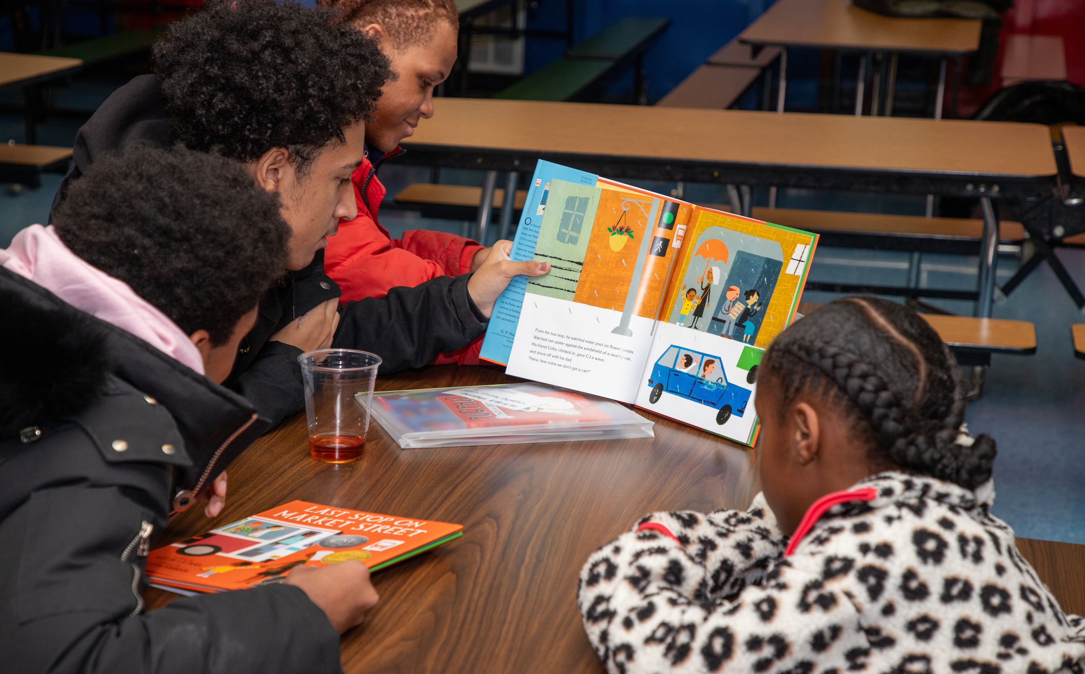 Students showing each other the book